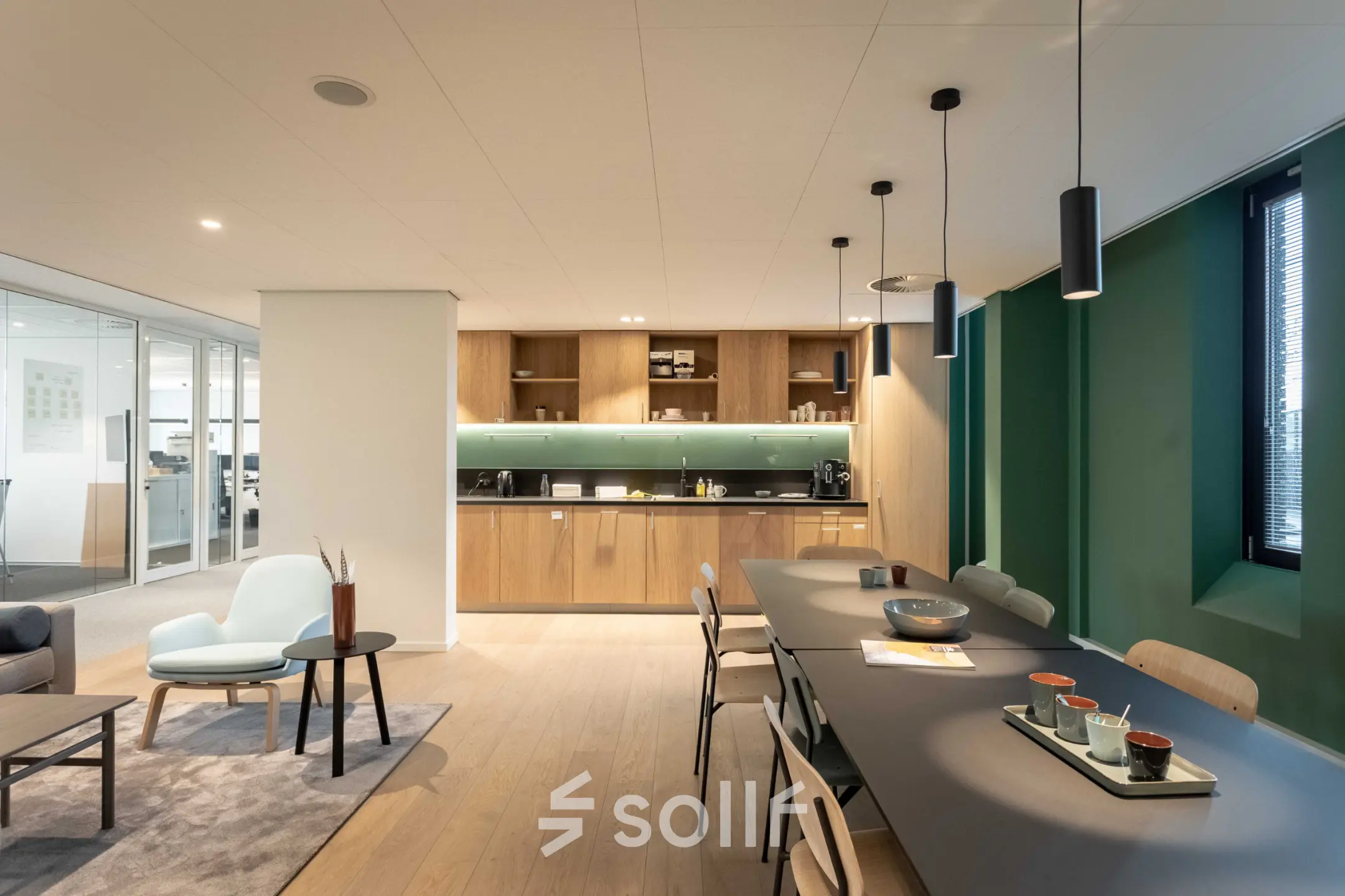 Modern office space for rent at Van Deventerlaan 31-51, Utrecht Papendorp, featuring a stylish interior with sleek furnishings, a long table, and a cozy seating area.