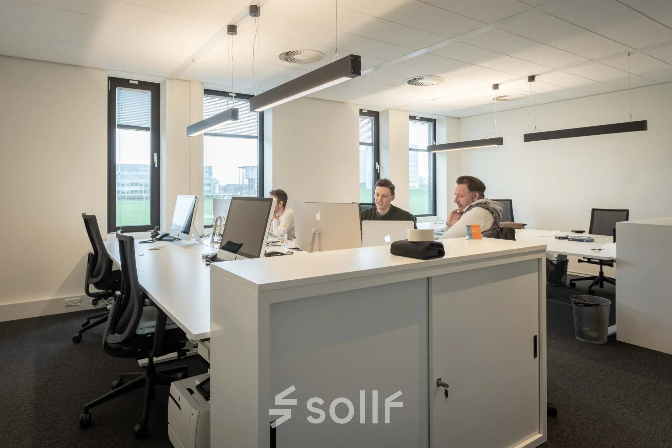 Bright, furnished office space at Van Deventerlaan 31-51, Utrecht Papendorp, featuring modern workstations and professionals collaborating. Ideal office space rental opportunity.