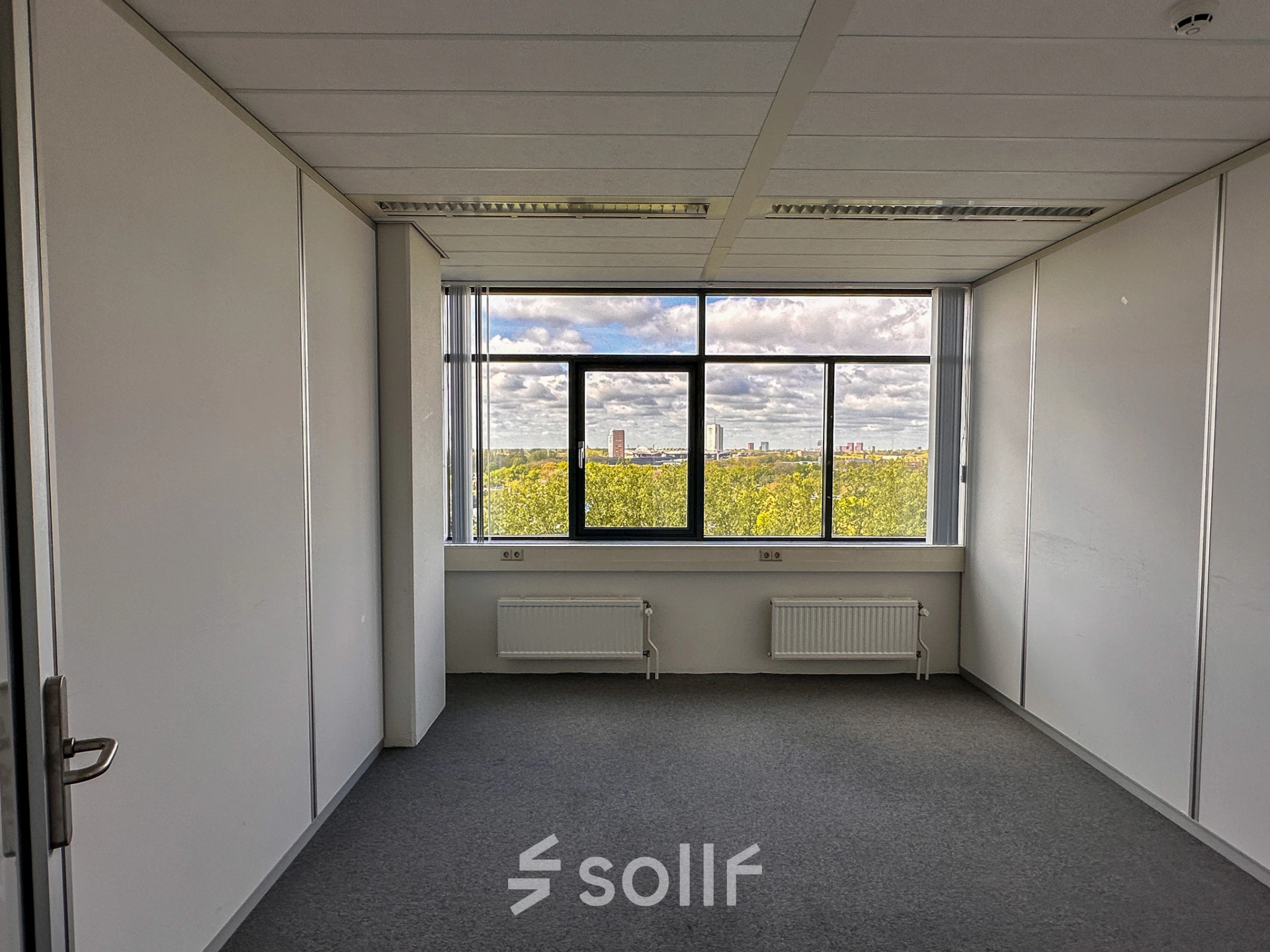 Bright office space at Daltonlaan 200, Utrecht Rijnsweerd, featuring a large window with a view of the city skyline, ideal for office space rental.