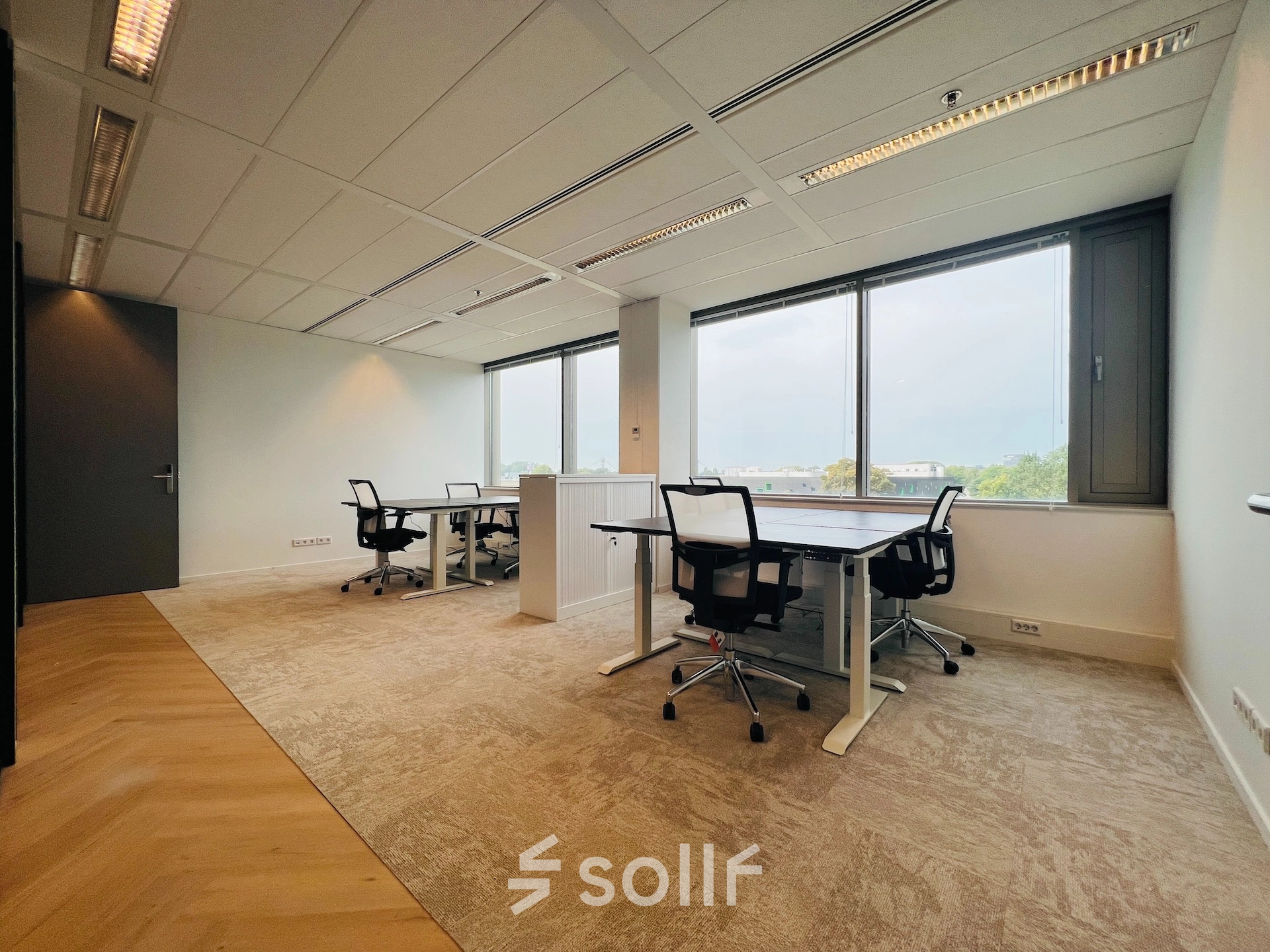 Furnished office space for rent in Utrecht South at Vliegend Hertlaan 15, featuring large windows and modern desks with chairs, ideal for workspace needs.