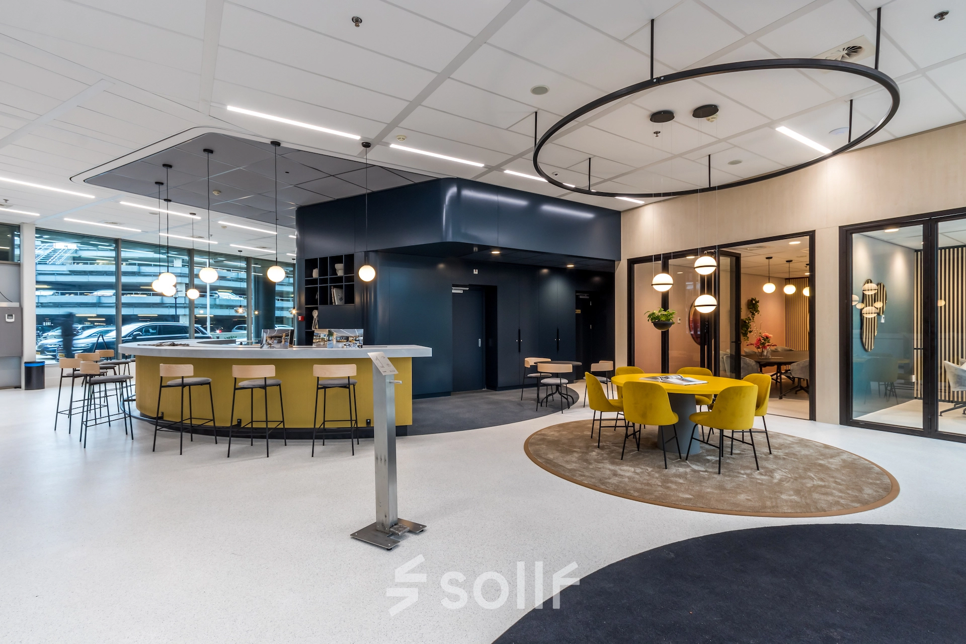 Bright, modern office space in Utrecht South, featuring a stylish lounge area with yellow chairs, round tables, and contemporary lighting. Ideal for office space rental opportunities.