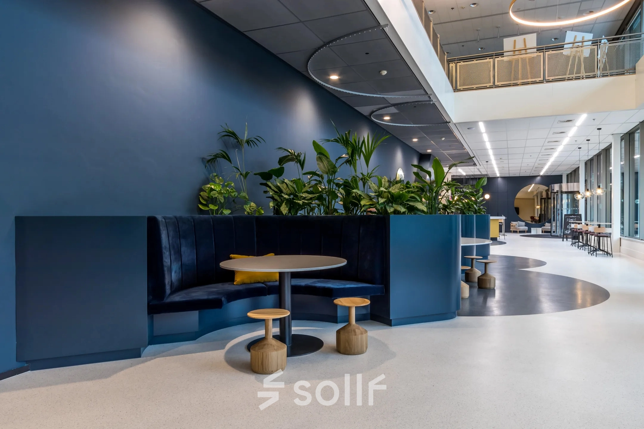 Modern office space rental at Vliegend Hertlaan 15, Utrecht South, featuring cozy seating with plants in a contemporary setting.