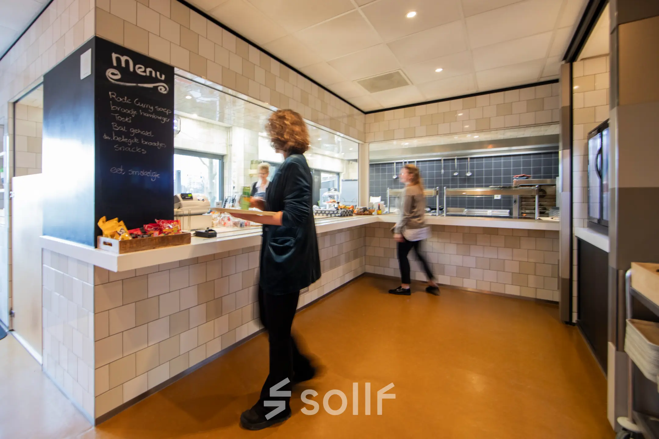 Bright office pantry at Winthontlaan 200, Utrecht South, where employees are selecting snacks and drinks, ideal for workplace relaxation. Consider renting this office space for modern convenience.