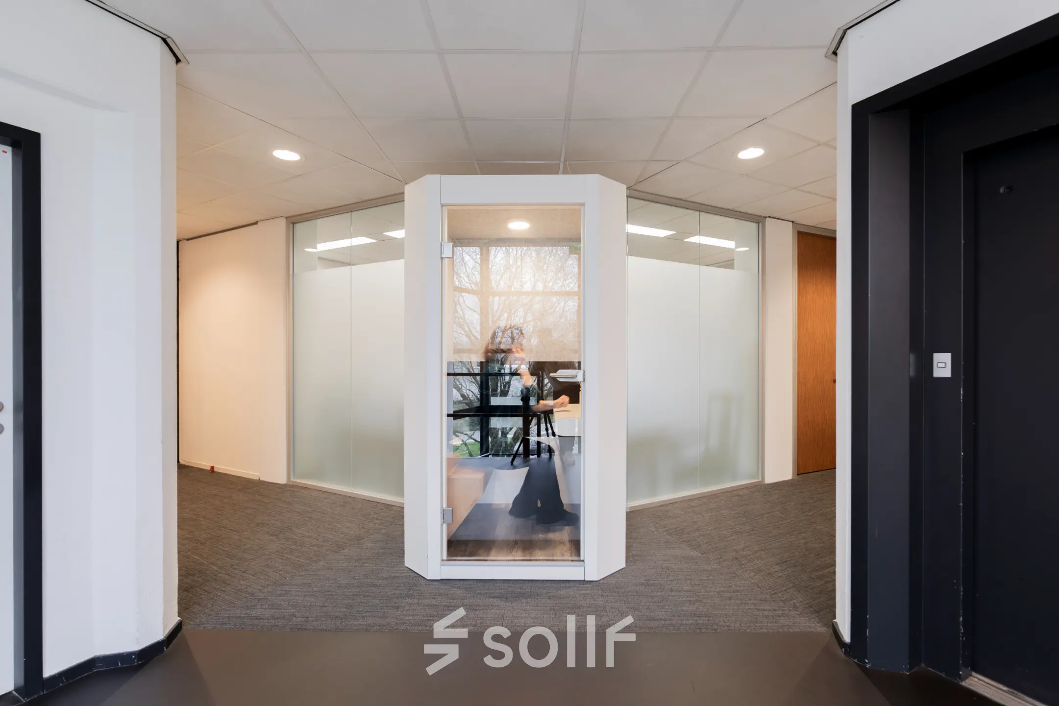 Modern office space for rent at Winthontlaan 200, Utrecht South, featuring a glass-walled workspace with a person working at a desk.