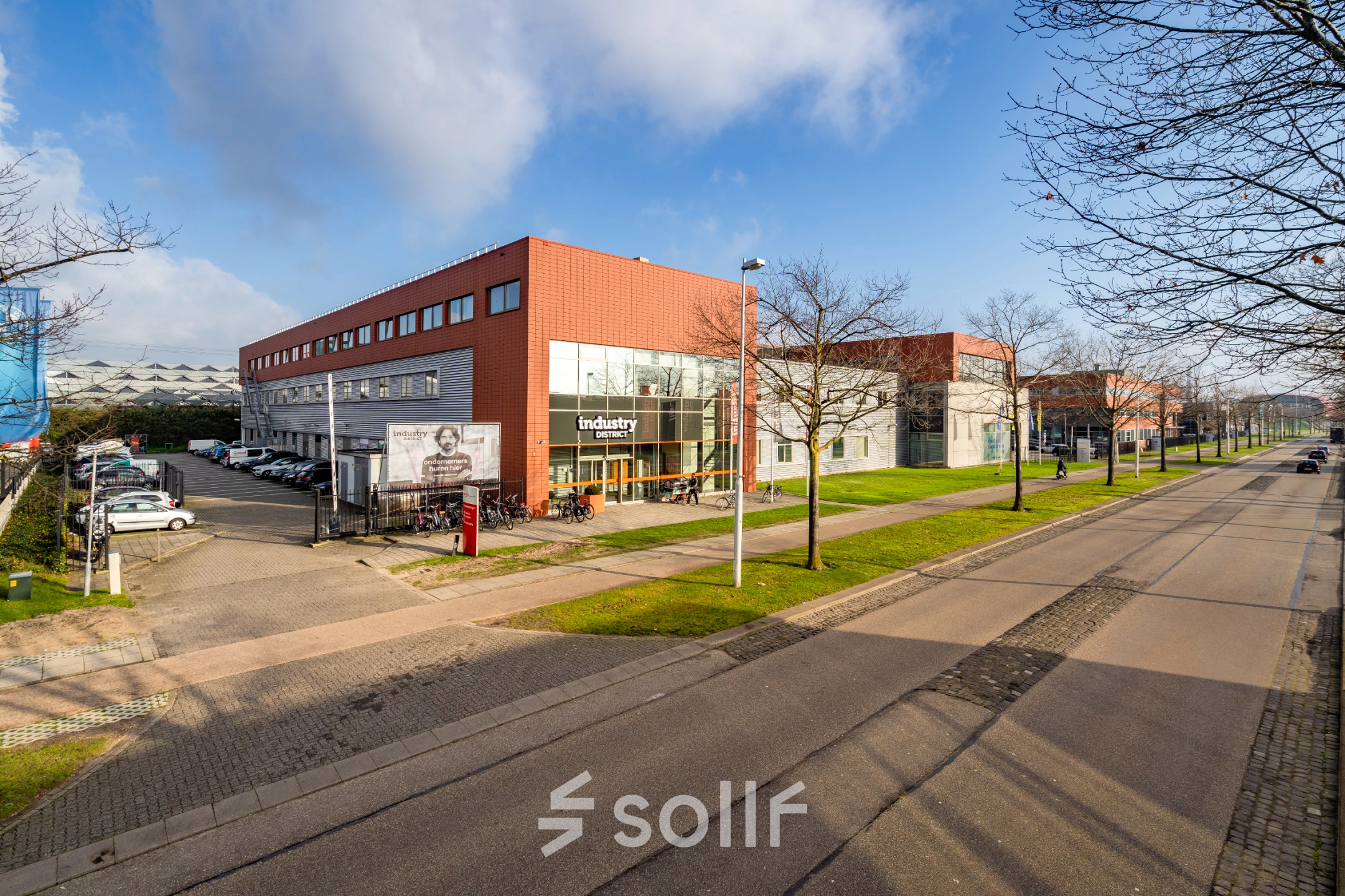 Exterior view of the office building located at Proostwetering 41, Utrecht West, showcasing modern architecture and ample parking, ideal for those seeking office space rental in a vibrant business district.