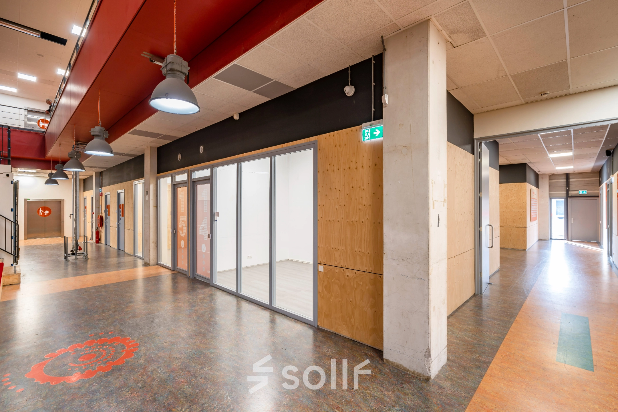 Contemporary interior hallway at Proostwetering 41, Utrecht West, suitable for office space rental. Features a modern design with glass-walled rooms and decorative flooring, offering a professional vibe for business activities.
