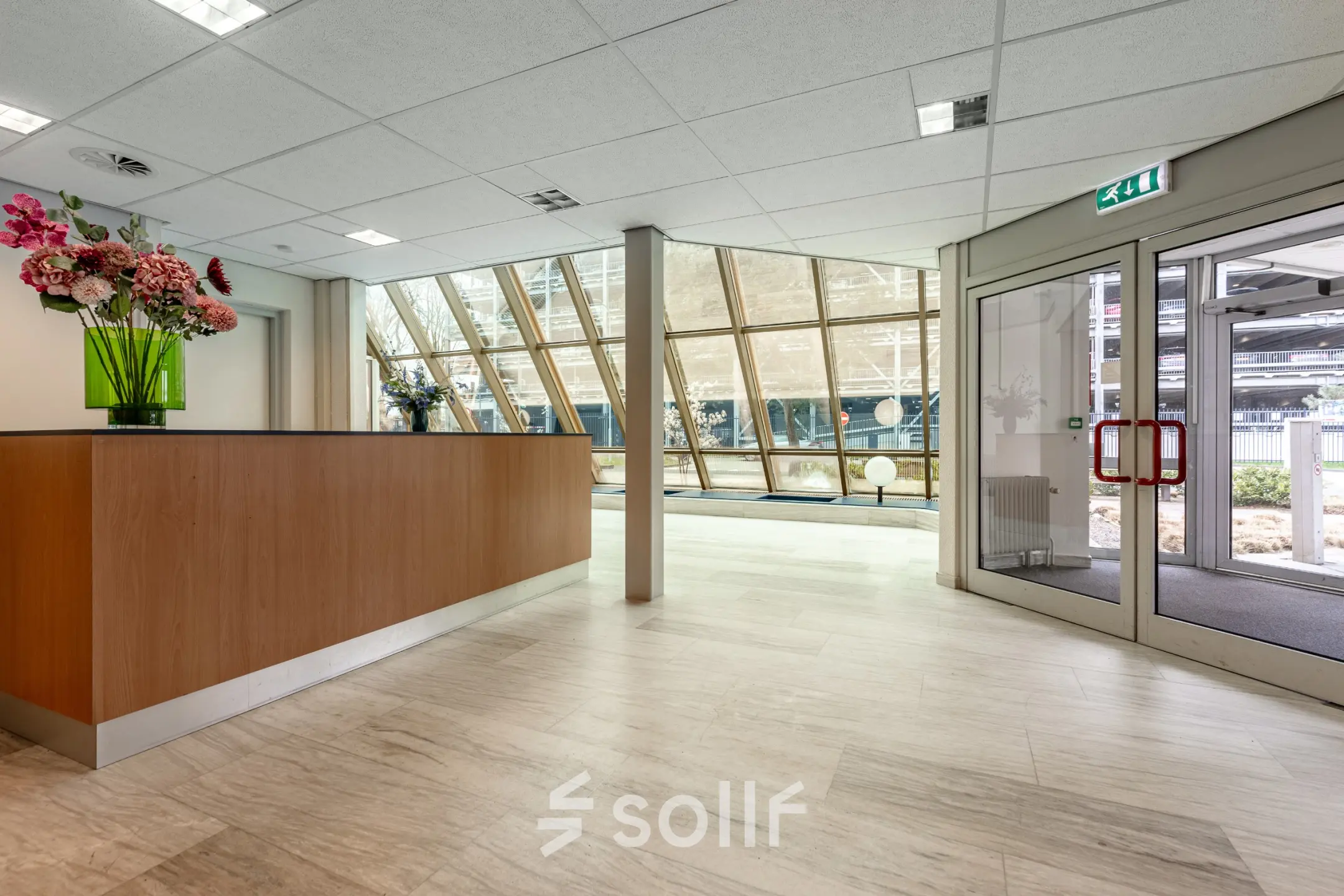 Bright office entrance at De Run 1141-1157, Veldhoven, featuring a welcoming reception desk and large windows for natural light.