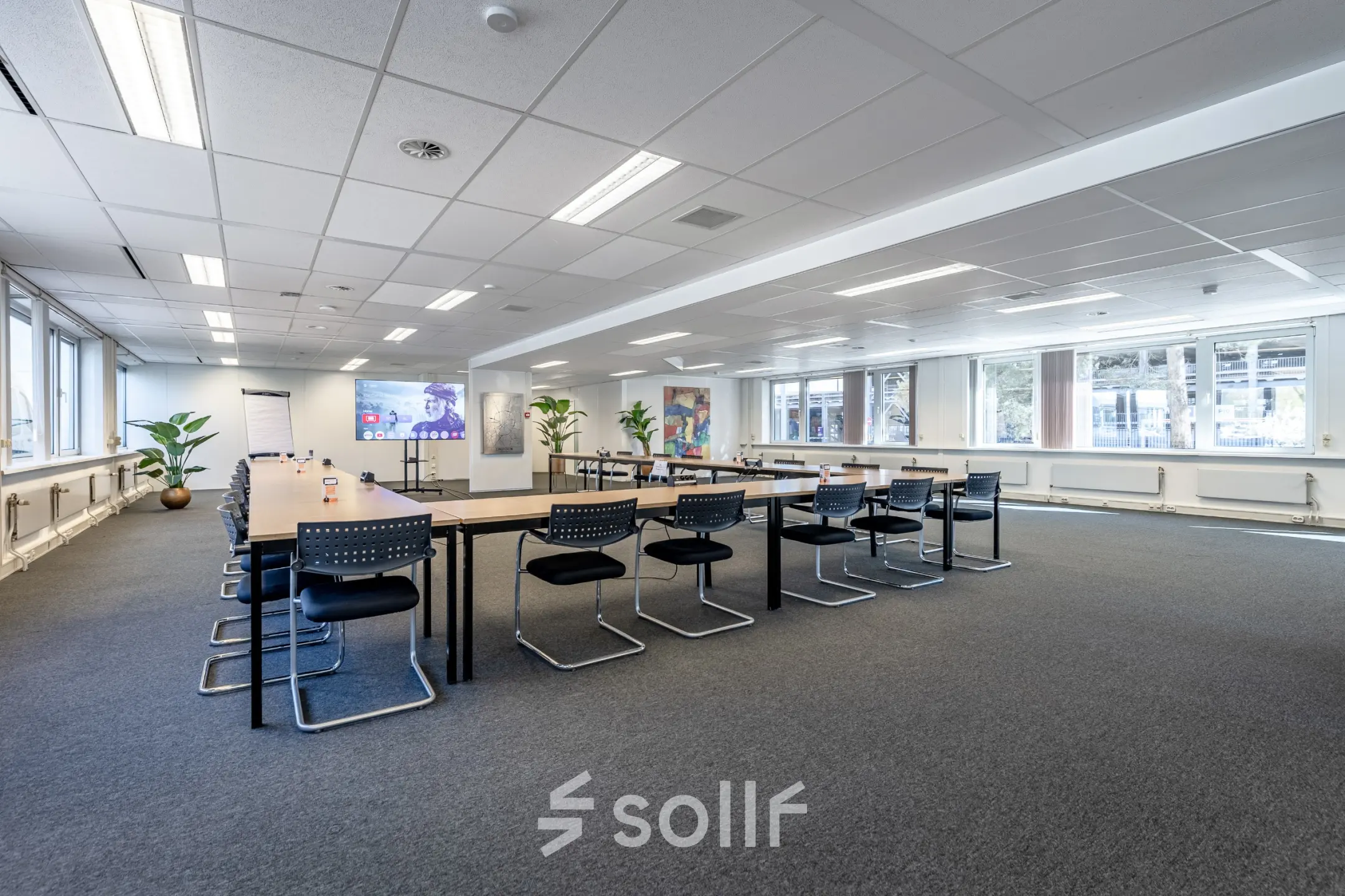 Spacious office space available for rent at De Run 1141-1157, Veldhoven, featuring a modern conference room setup with tables and chairs.