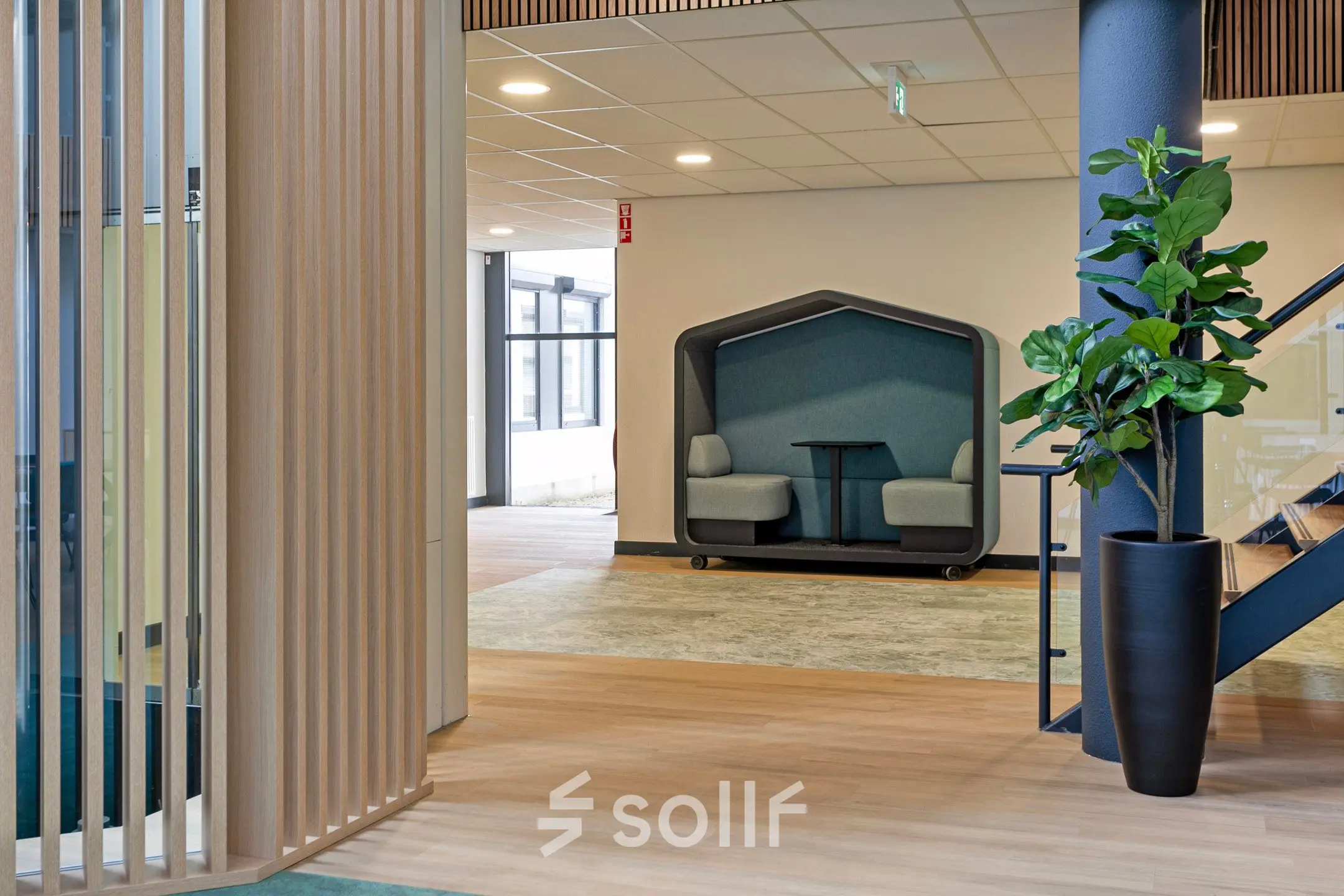 Modern office space with comfortable seating at De Run 4312, Veldhoven, featuring a stylish lounge area with enclosed booths for meetings. Ideal for office space rental.