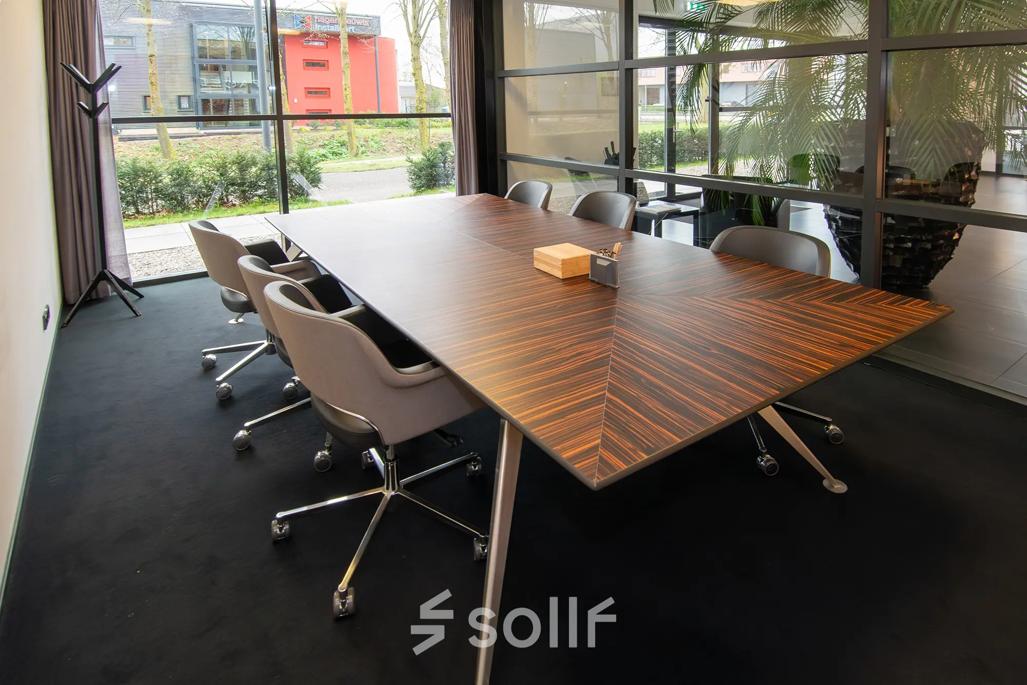 Spacious conference room at Gildestraat 13, Velp with a sleek wooden table and comfortable chairs, ideal for office space rental.