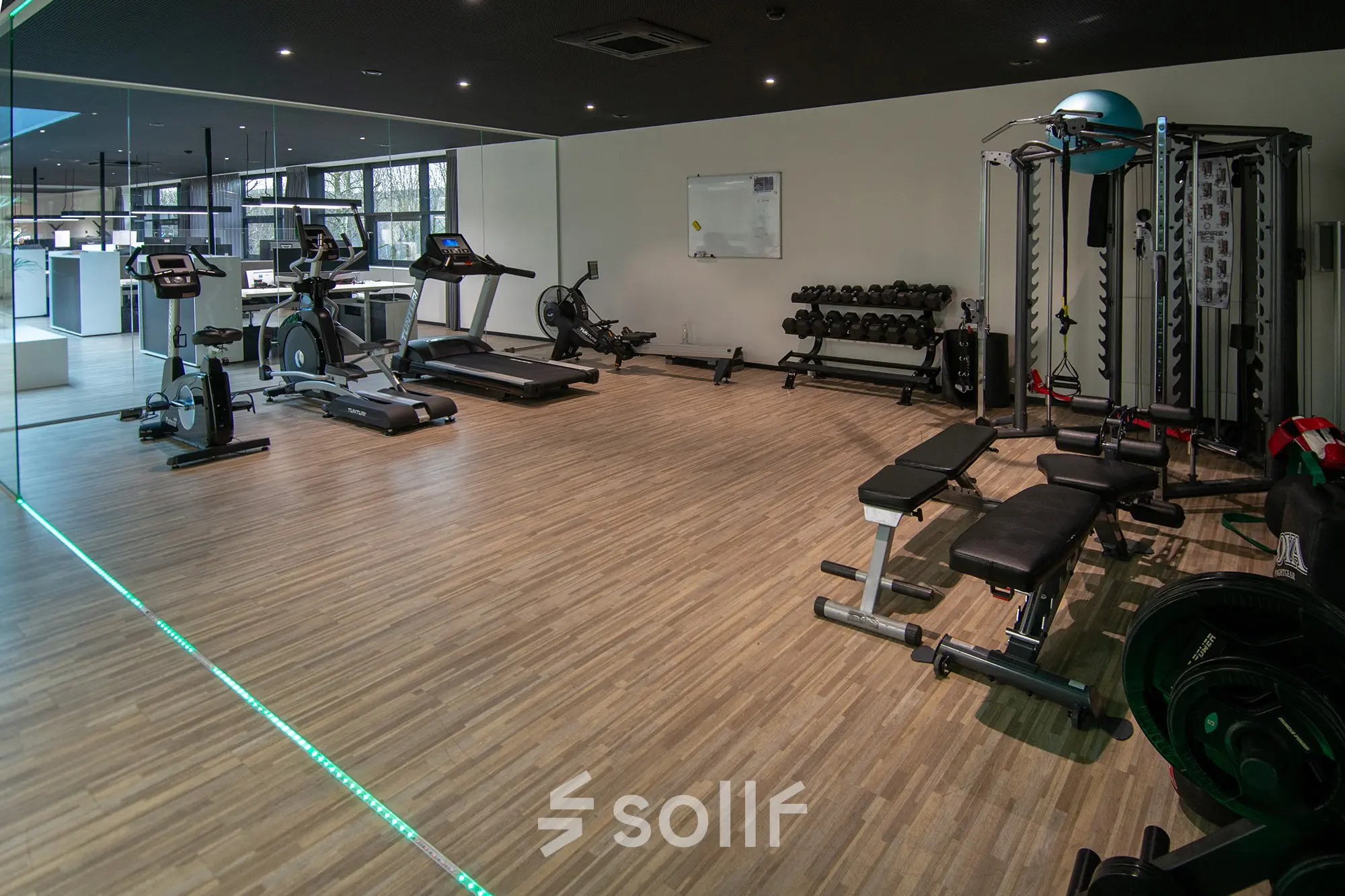 Modern fitness area available for office space rental at Gildestraat 13, Velp, featuring exercise equipment and mirrored walls for an invigorating work environment.