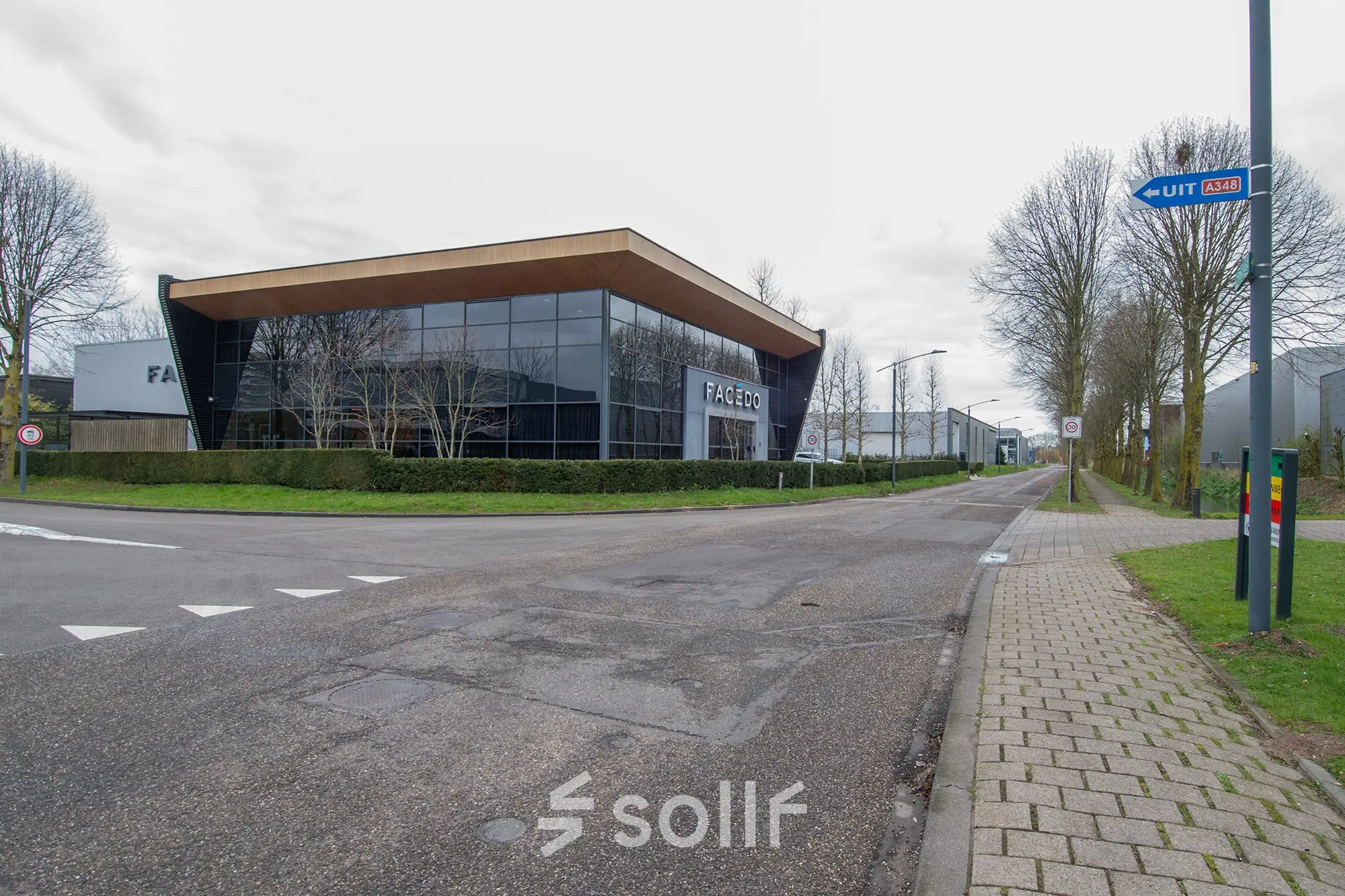 Exterior view of the office building at Gildestraat 13, Velp, featuring large glass windows and modern architecture, ideal for office space rental.