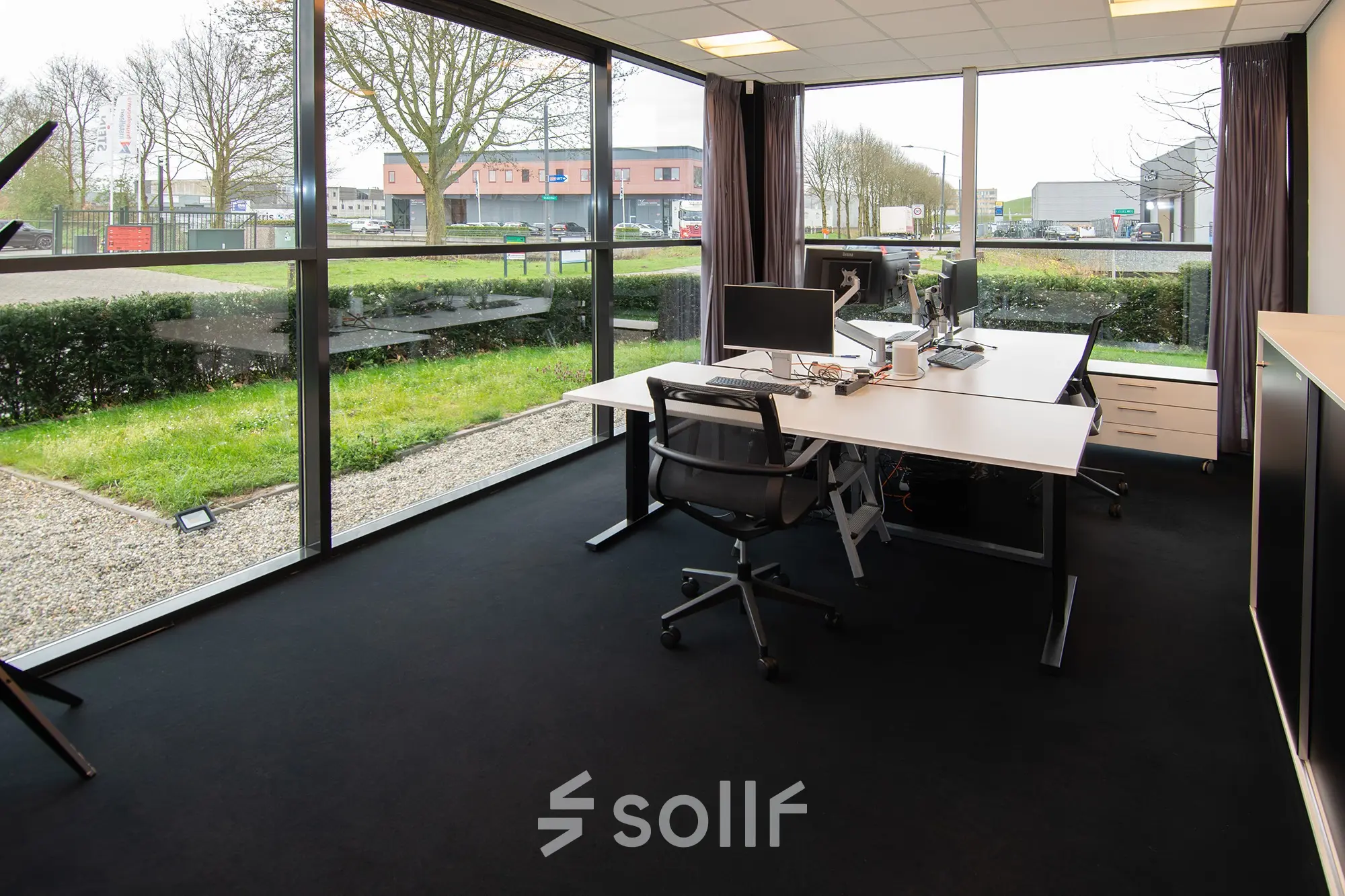 Corner office space to rent at Gildestraat 13, Velp, featuring large windows, desks, and chairs, suitable for business activities.