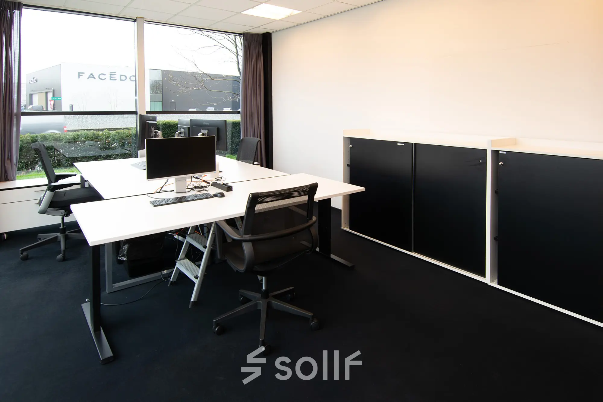 Modern office space at Gildestraat 13 in Velp with sleek desks, chairs, and a window view, ideal for rental.