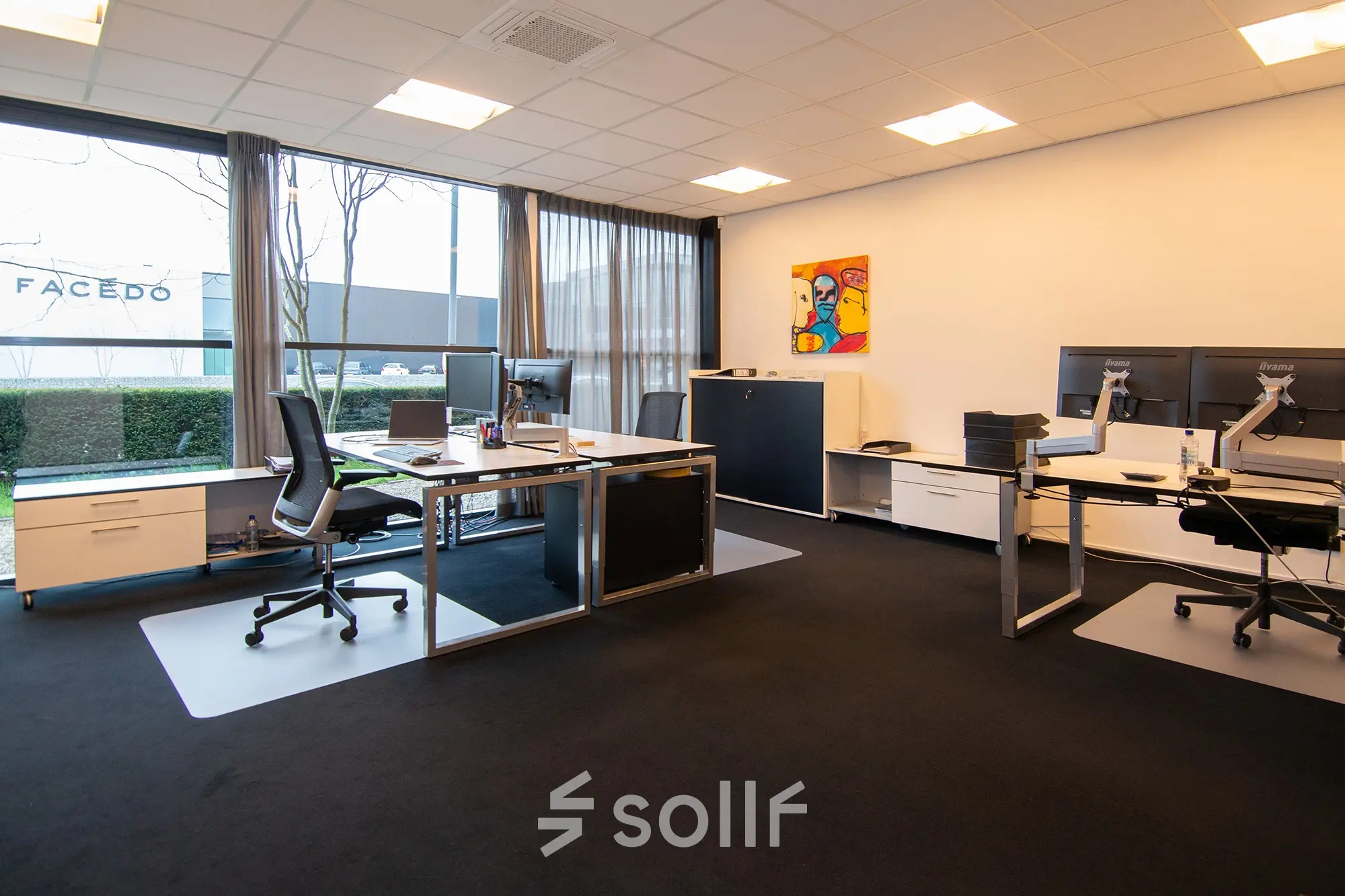Modern office space rental at Gildestraat 13, Velp, featuring spacious desks and large windows with natural light.