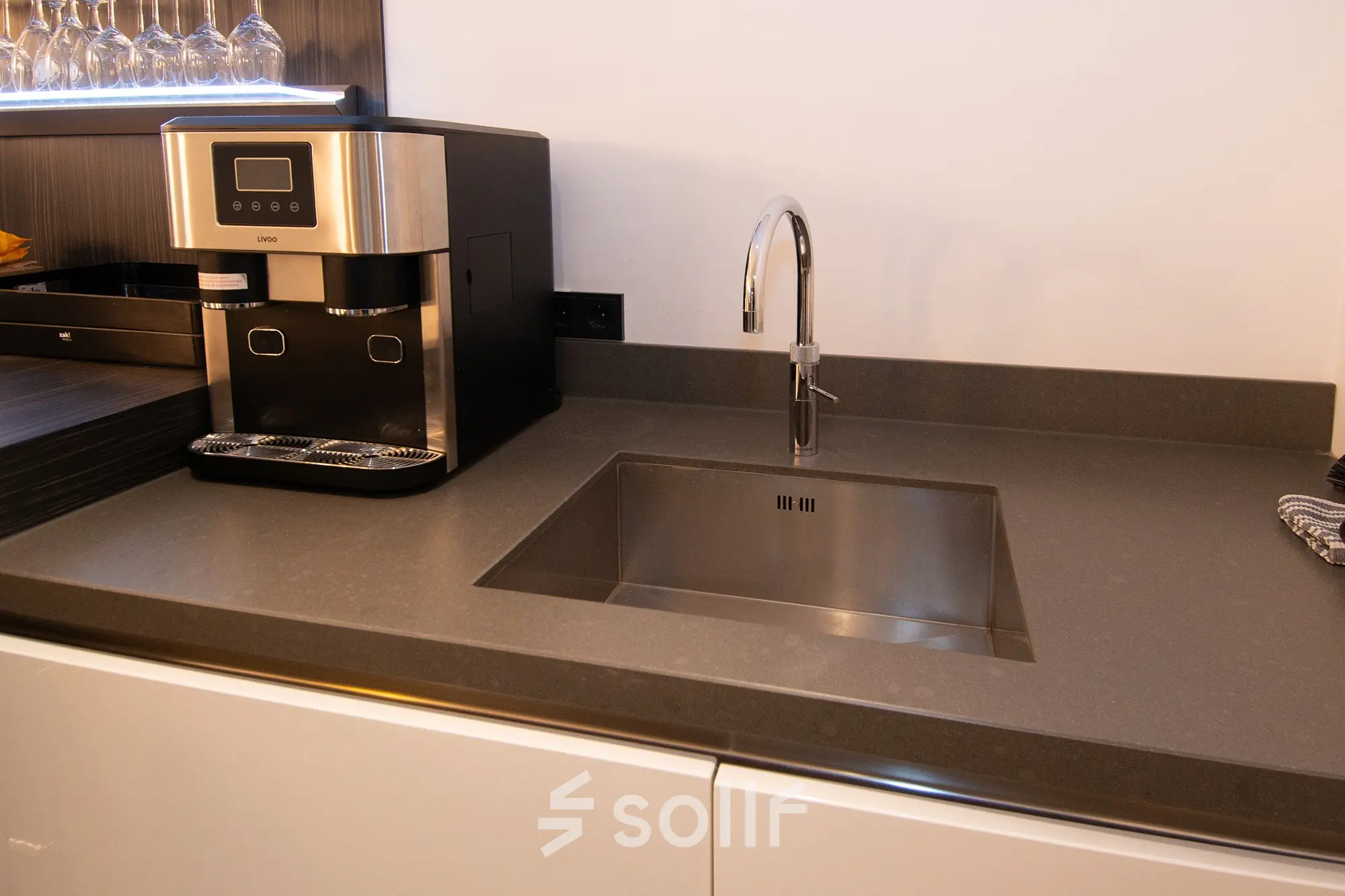 Kitchen area with a sleek counter and modern coffee machine at office space rental in Velp.