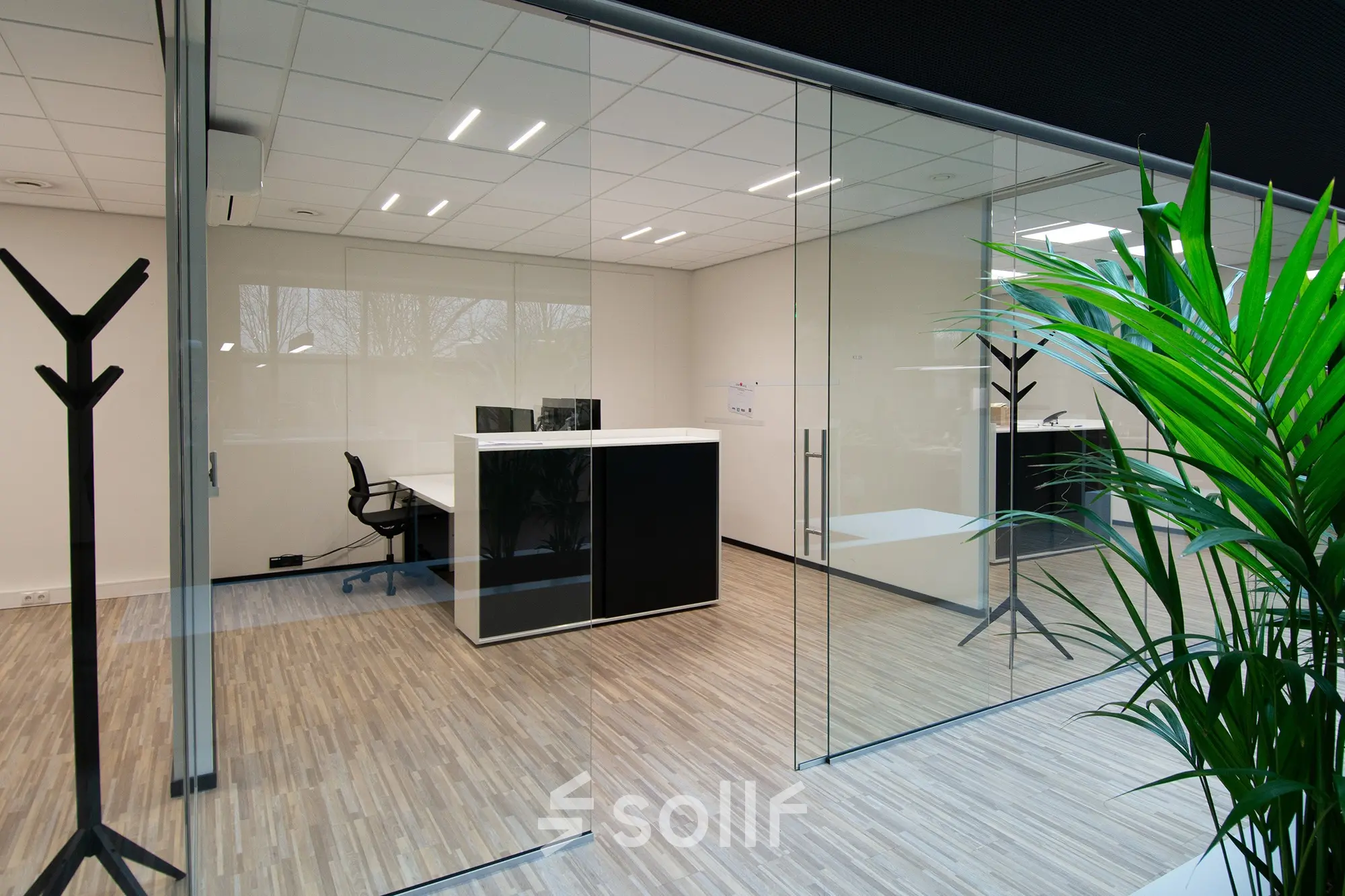 Modern office space featuring sleek wooden flooring and glass partitions at Gildestraat 13, Velp. Perfect for your next office space rental.