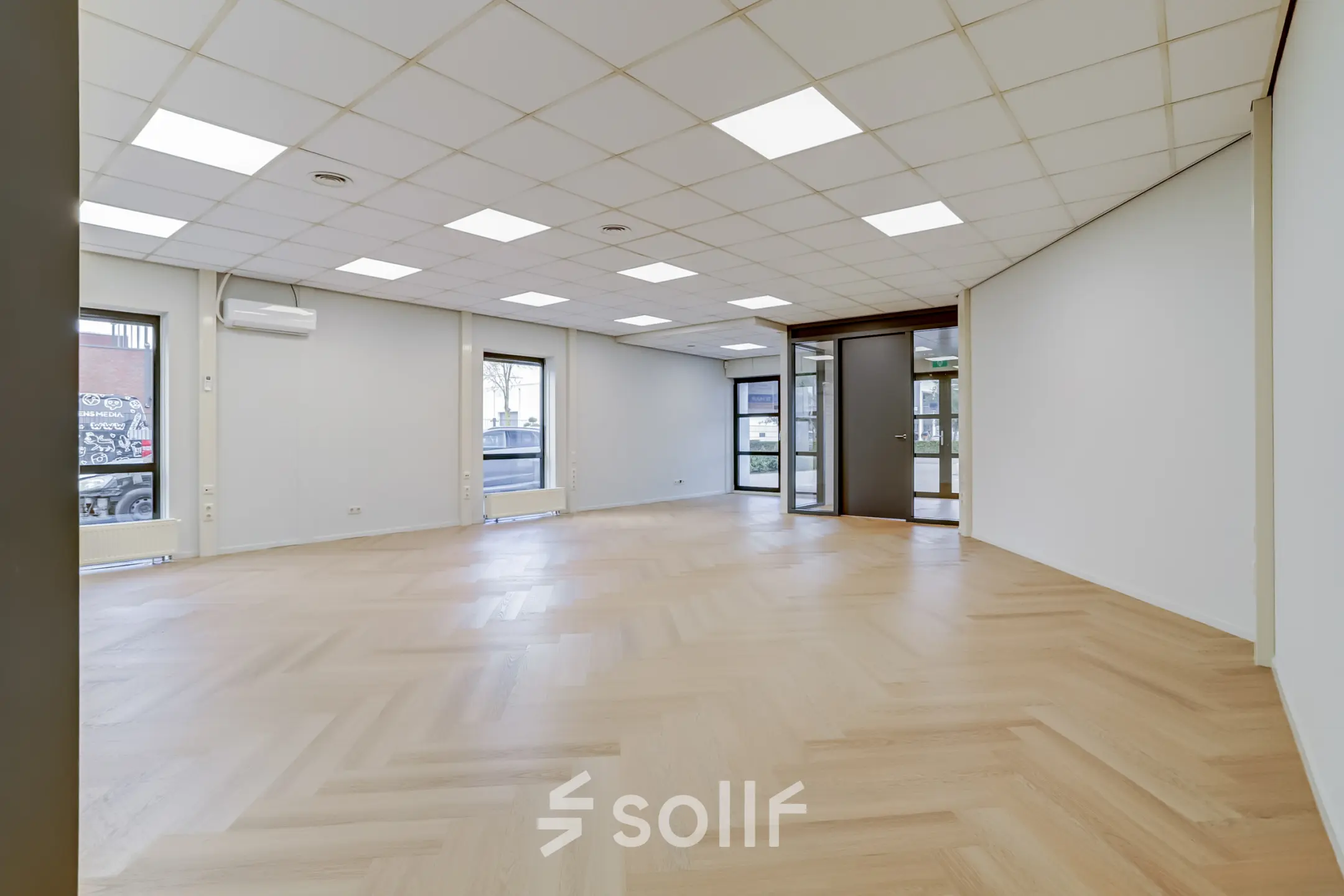 Spacious office space for rent at Keizersveld 47, Venray, featuring large windows and wooden floors, ready for customization.