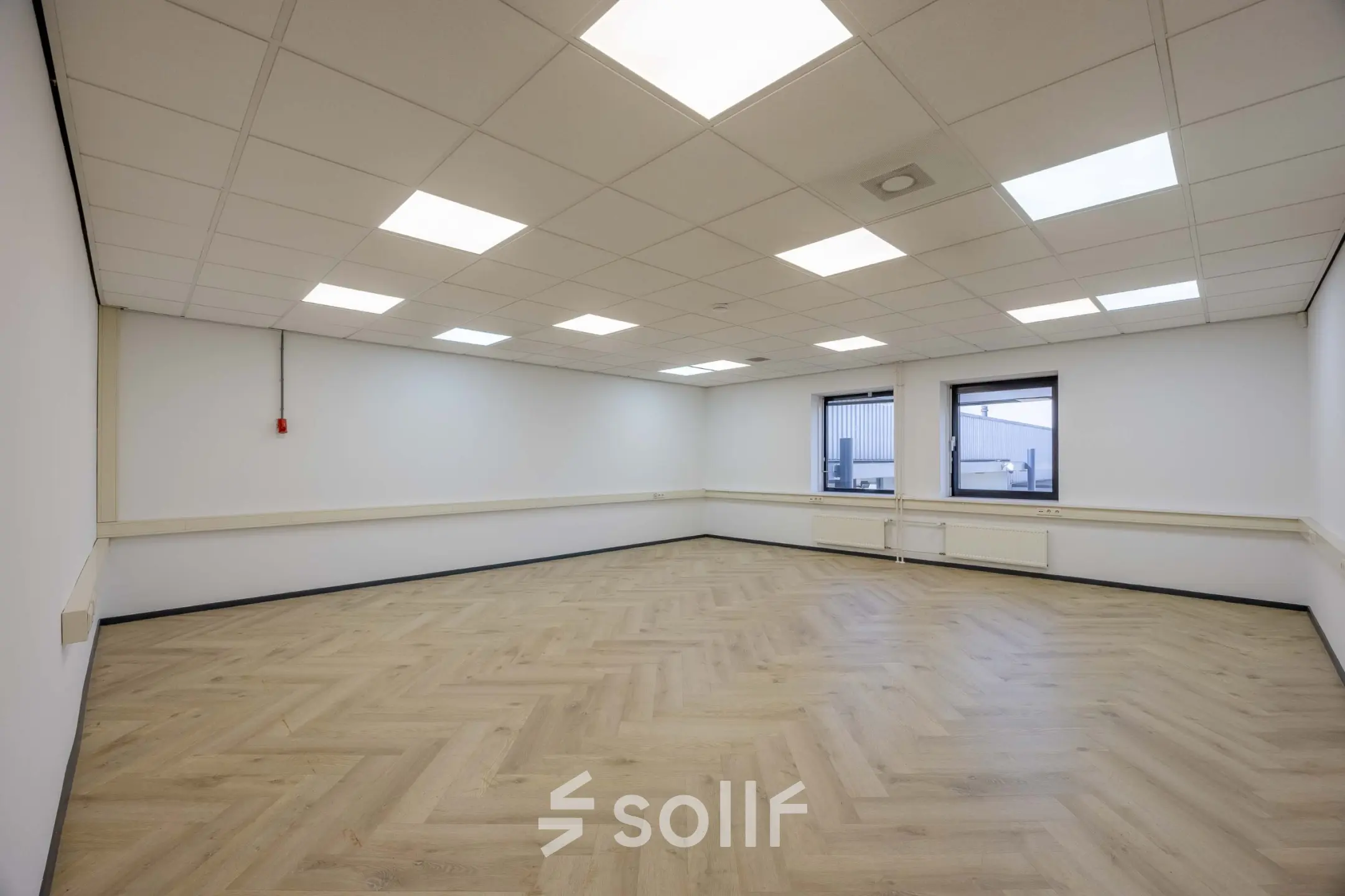 Spacious, well-lit office space with wooden flooring and ceiling lights at Keizersveld 47, Venray, ideal for office space rental.