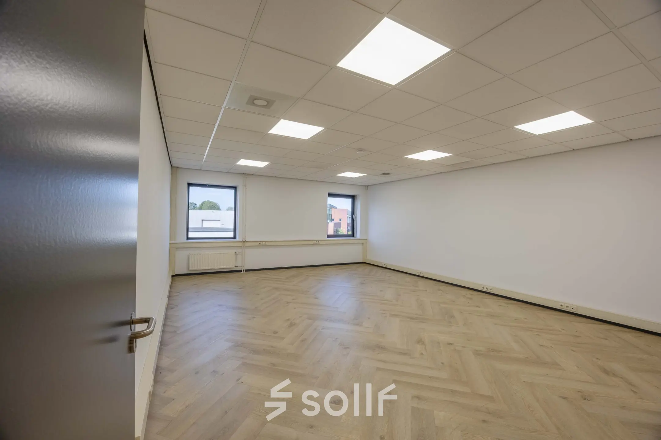 Bright office space with wooden flooring and large windows at Keizersveld 47, Venray, available for rent.