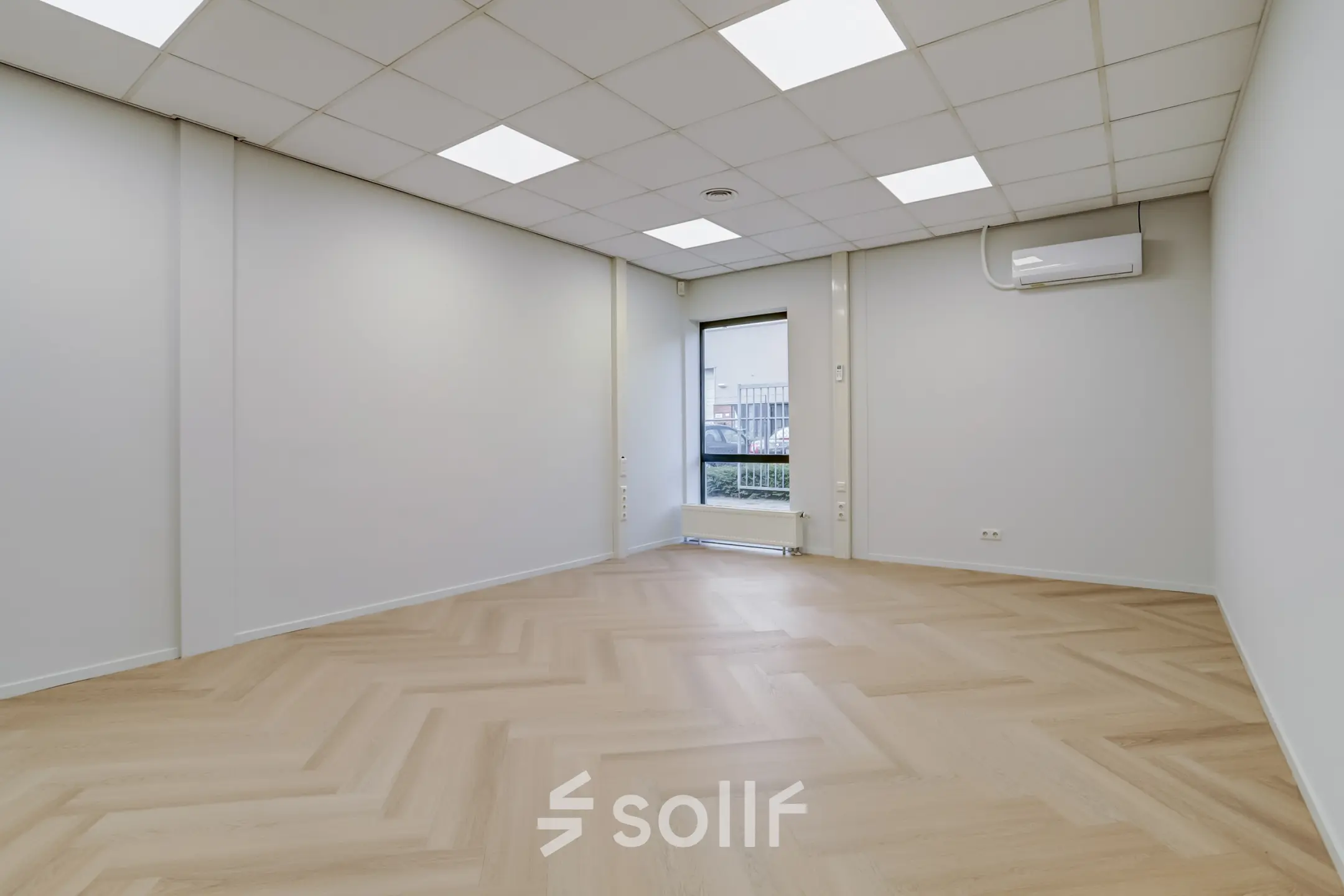 Bright office space available for rent at Keizersveld 47, Venray, featuring wooden flooring and natural lighting through large windows.