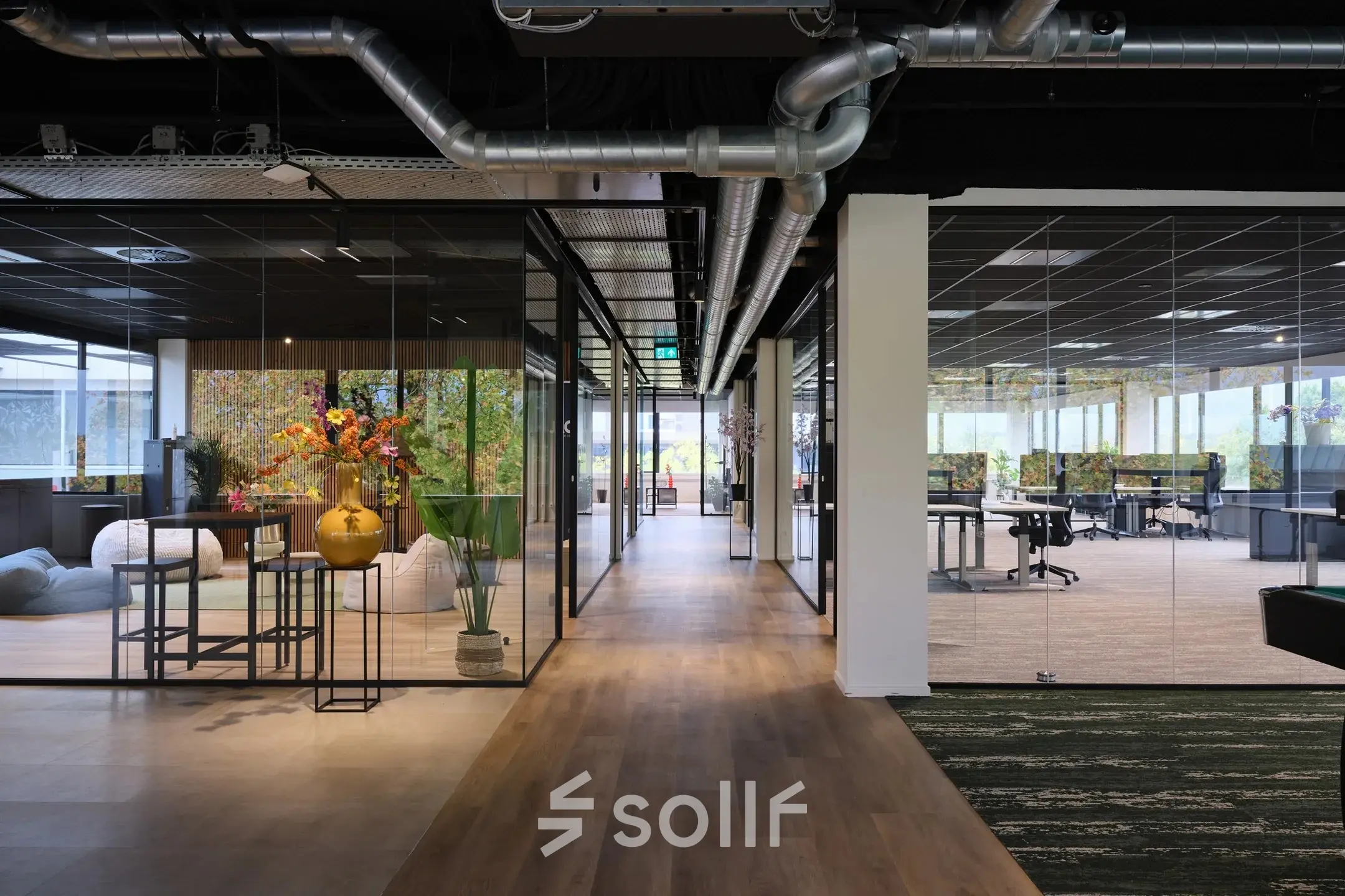 Modern office at Havenweg 24, Vianen Utr featuring a sleek open floorplan with glass partitioned areas and vibrant decor. Ideal for office space rental.