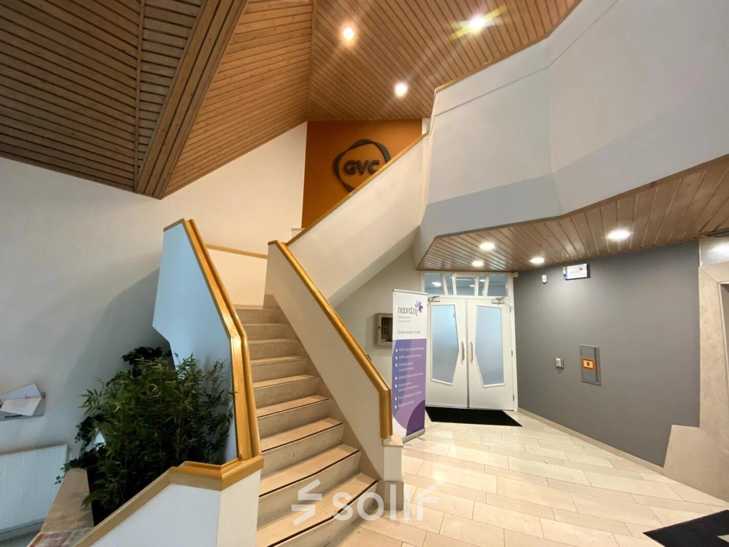 An inviting entrance at Loire 104 - 206, Voorburg, perfect for your next office space rental. Stylish indoor architecture leads to rentable spaces above.