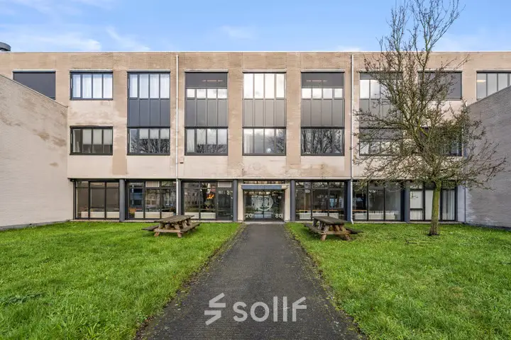 Exterior view of the office building at Agro Business Park 22, Wageningen, featuring a pathway leading to the entrance, ideal for office space rental.
