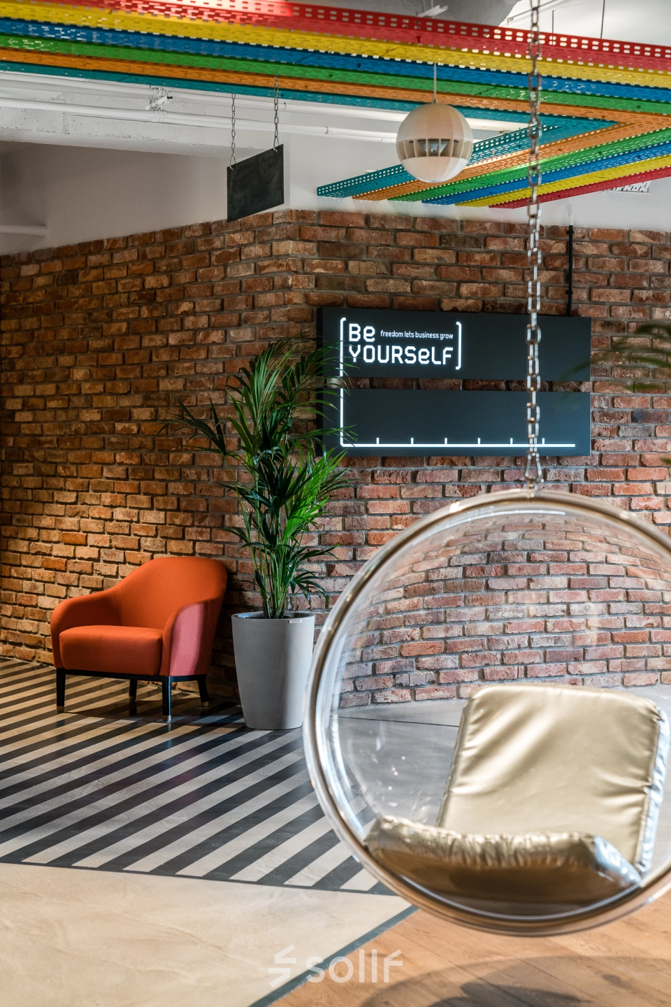 Stylish office space with exposed brick walls and modern decor at Konstruktorska 11 in Warsaw Mokotow, ideal for office space rental.