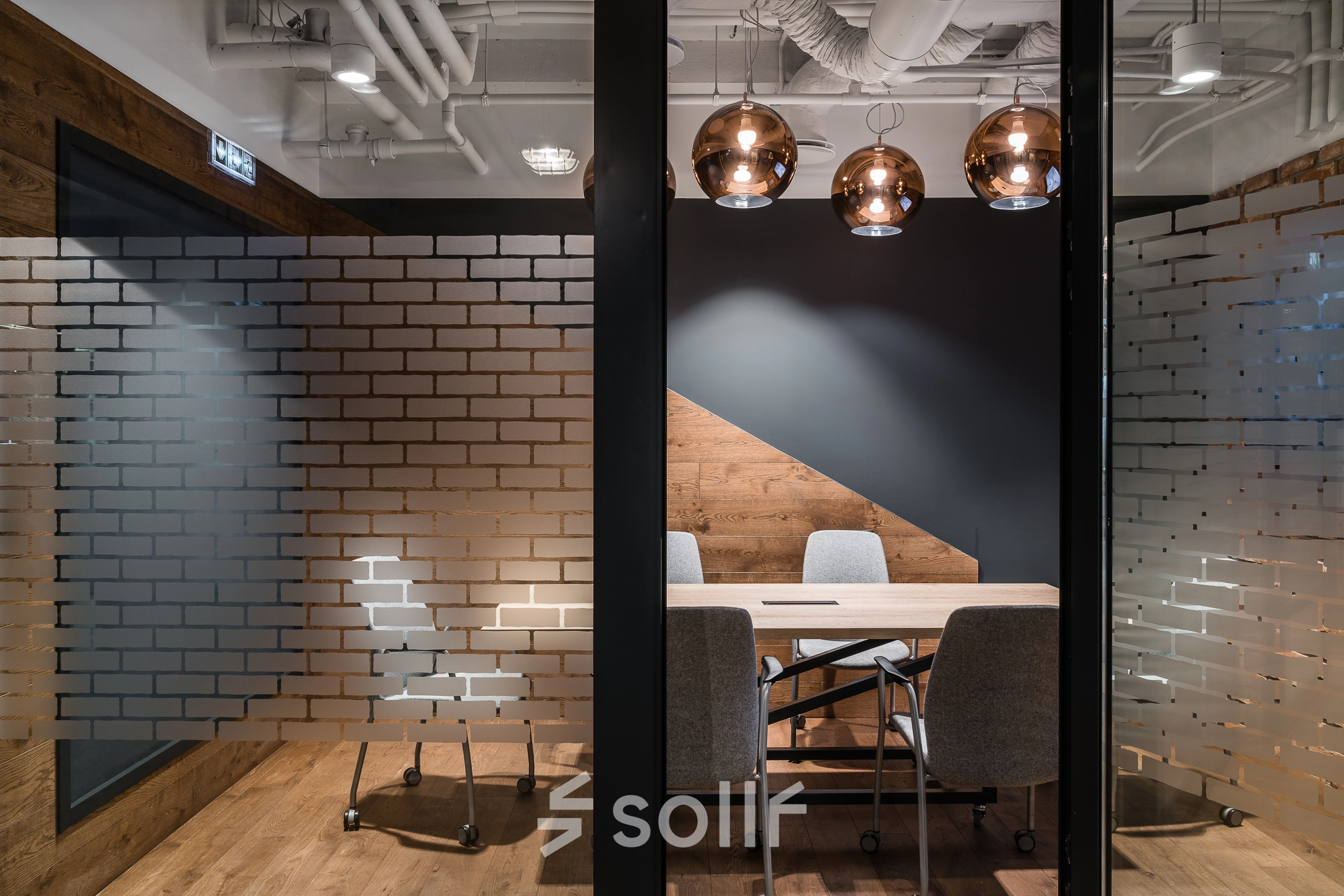 A stylish conference room with a wooden table and modern chairs, located at Konstruktorska 11, Warsaw Mokotow, ideal for office space rental.