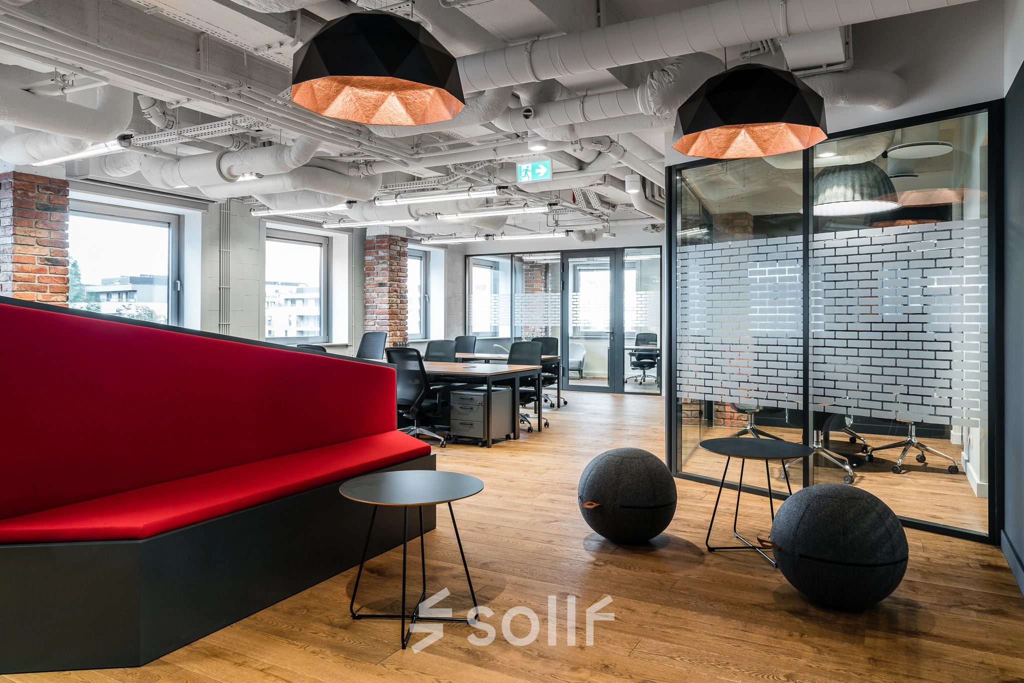 Modern furnished office space for rent at Konstruktorska 11, Warsaw Mokotow, featuring stylish seating and ample workstations.