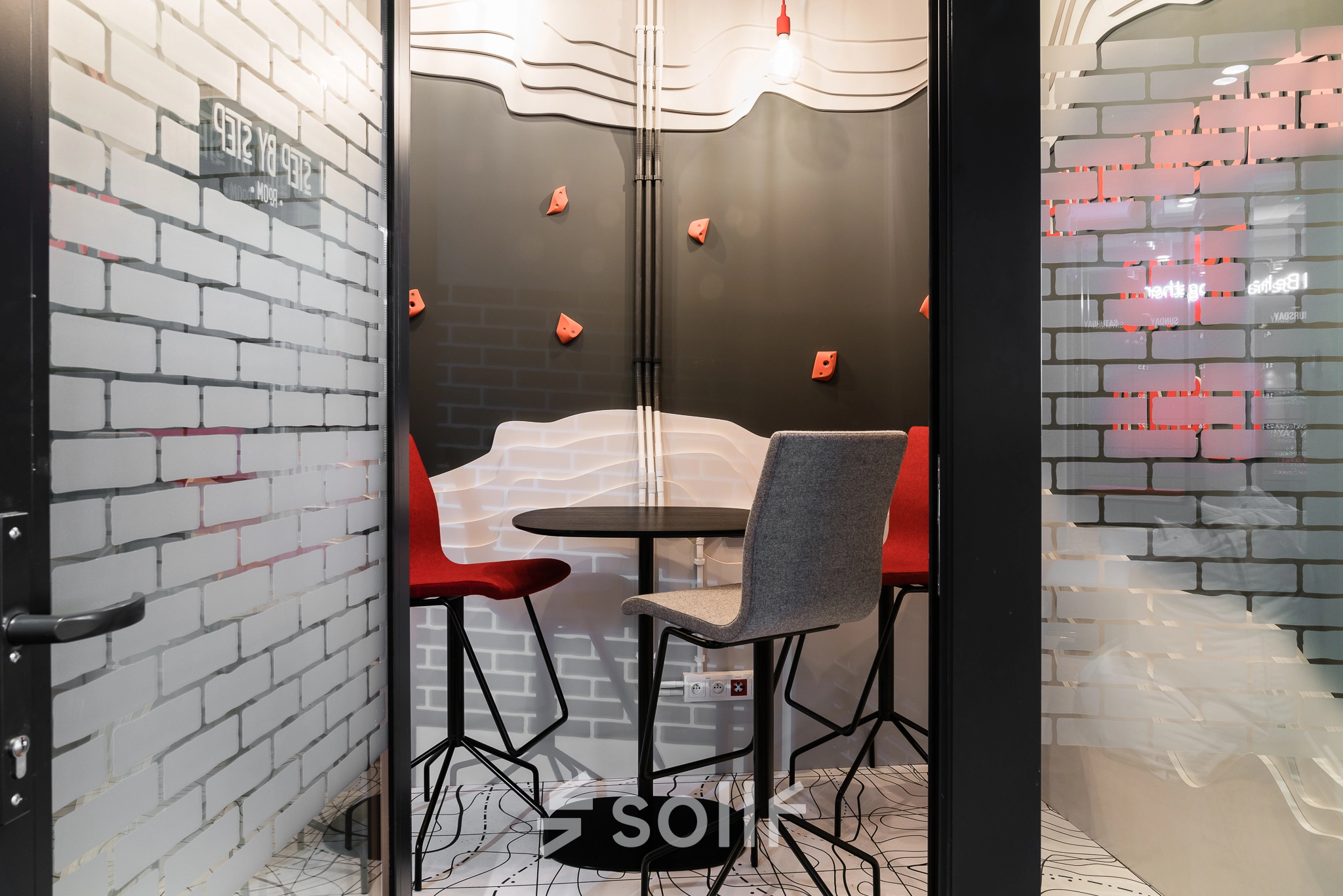Furnished interior office space at Konstruktorska 11, Warsaw Mokotow, featuring a small meeting area with modern chairs and a table. Ideal for office space rental or office to rent needs.