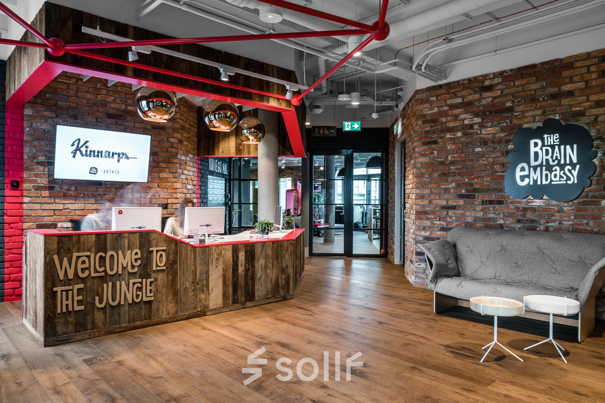 Stylish office space at Konstruktorska 11, Warsaw Mokotow, featuring a welcoming reception area with modern decor and wooden accents. Perfect for office space rental.