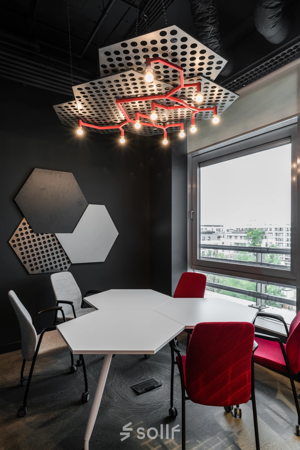 Modern furnished office space at Konstruktorska 11 in Warsaw Mokotow, featuring a unique ceiling design and stylish furniture. Ideal for rent as a collaborative workspace.