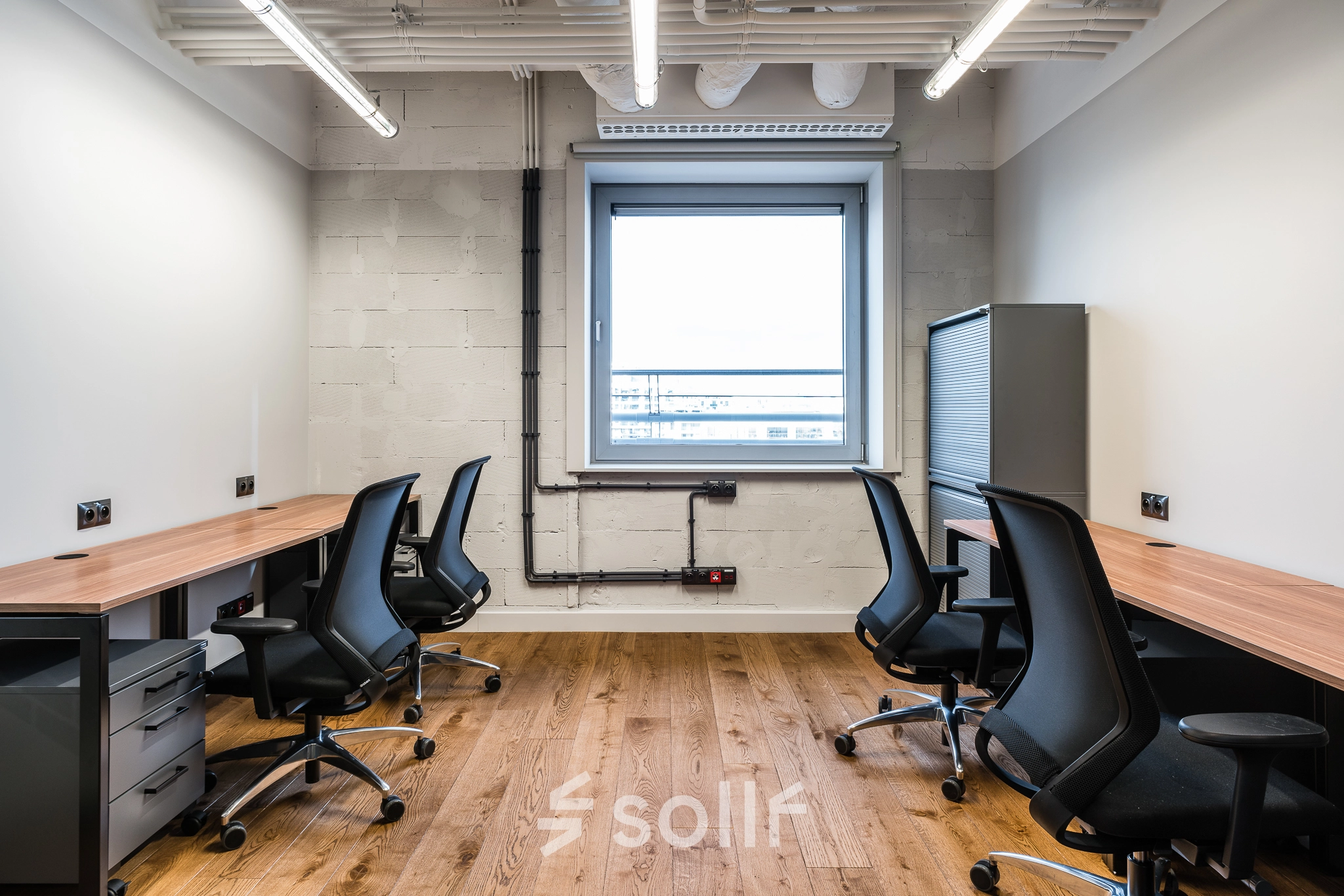 Furnished office space for rent at Konstruktorska 11, Warsaw Mokotow, featuring multiple workstations and modern lighting.