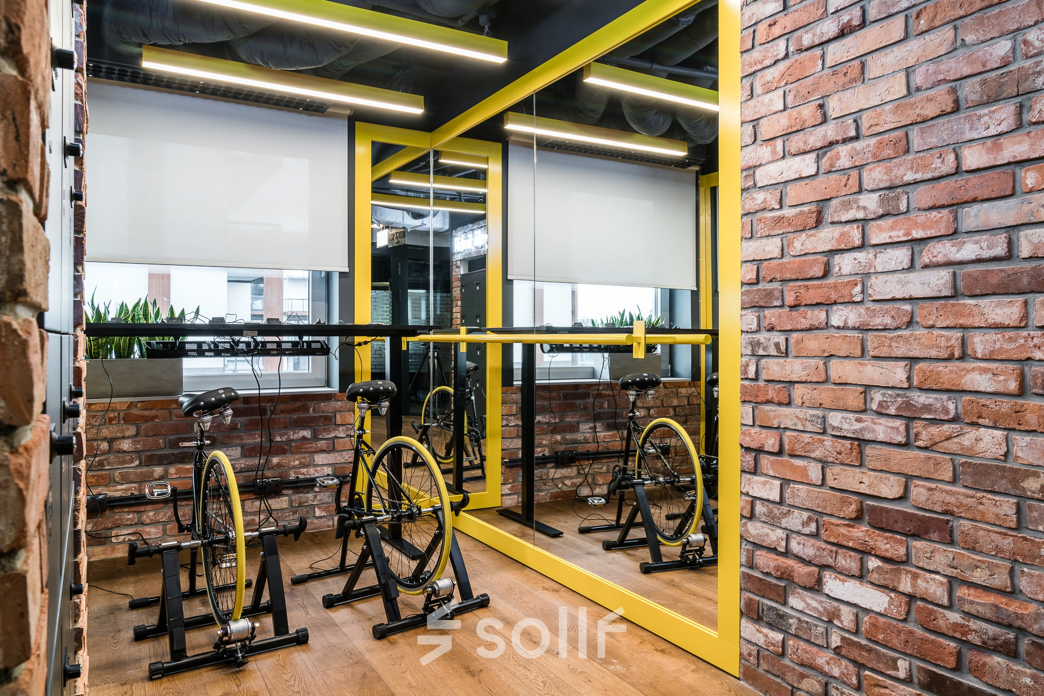Interior space at Konstruktorska 11, Warsaw Mokotow featuring stationary bicycles, ideal for informal meetings. Consider this office space rental for a dynamic work environment.