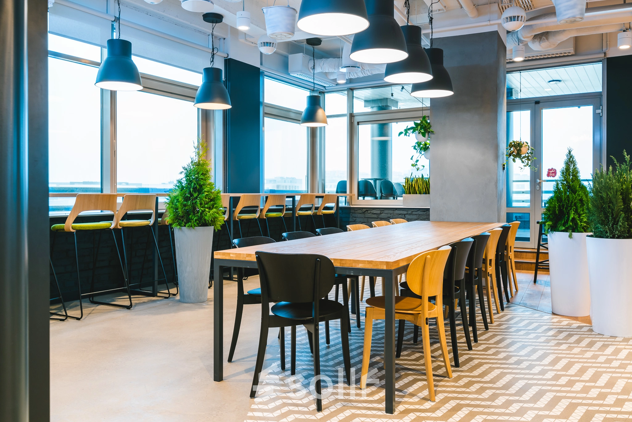 Furnished office space with a long wooden table and chairs, situated in Warsaw Mokotow. Ideal for office space rental with natural lighting and modern decor.