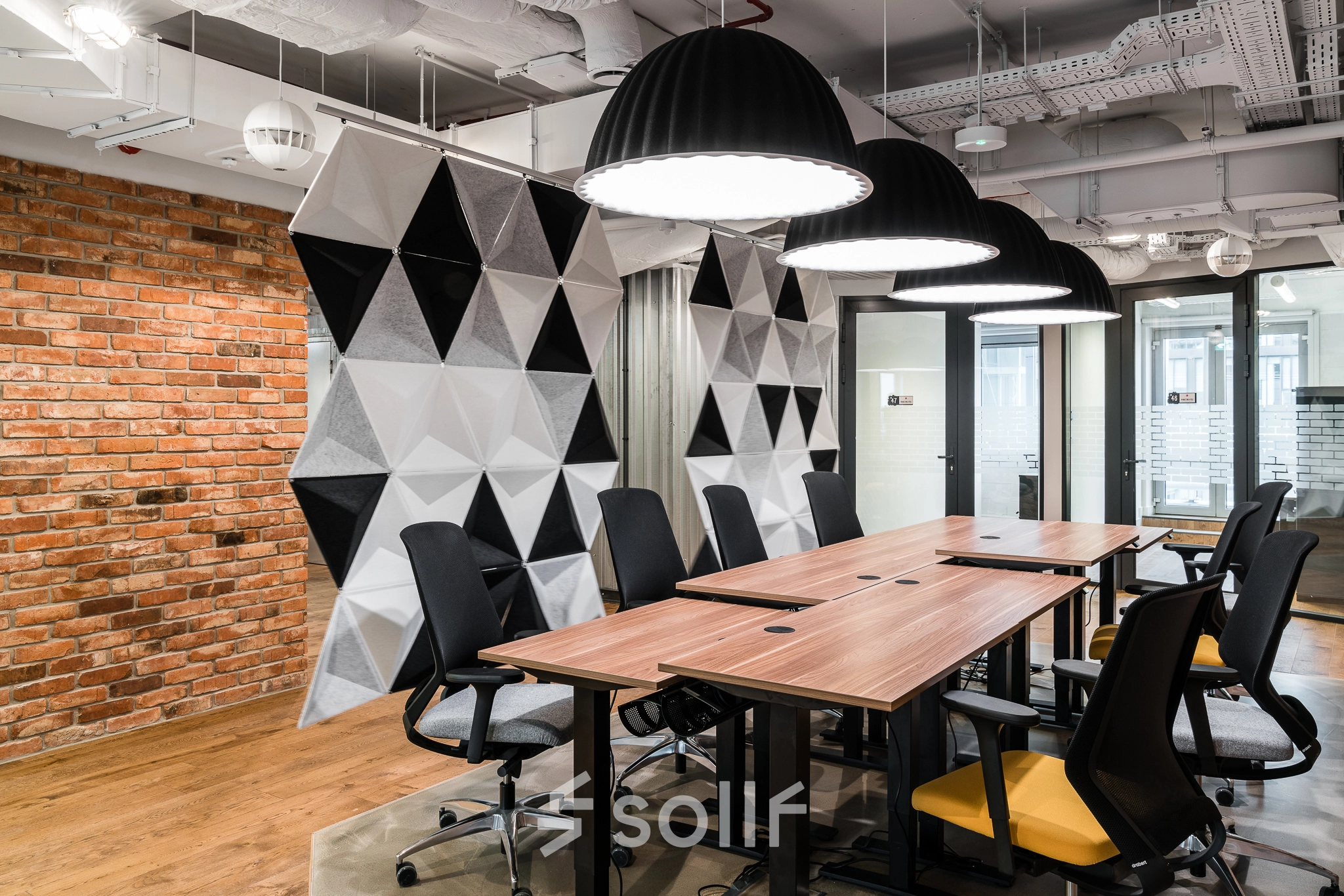 Modern office space at Konstruktorska 11, Warsaw Mokotow, featuring stylish furnishings and geometric decor, ideal for rent office space seekers.