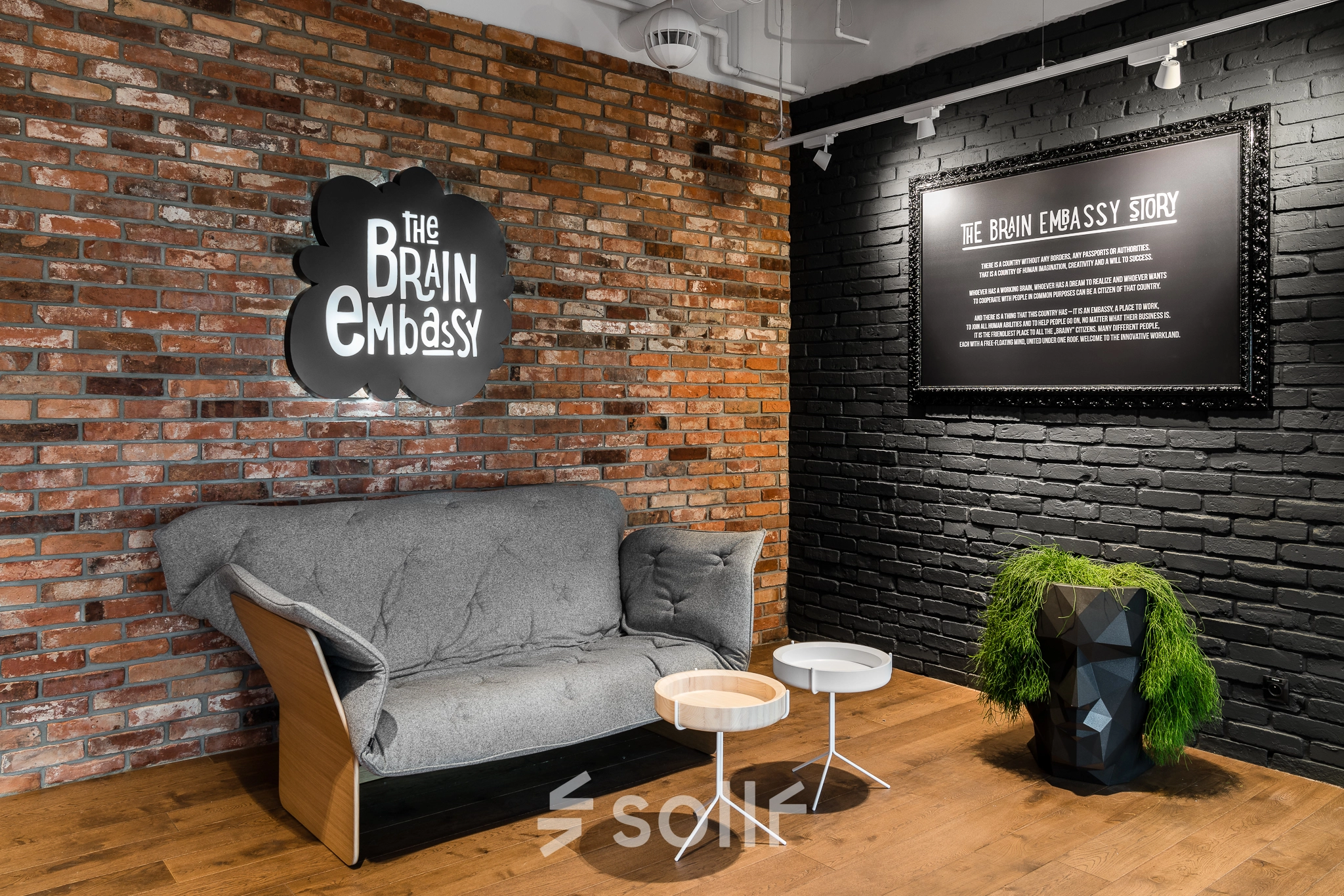 Cozy lounge area at Konstruktorska 11 in Warsaw Mokotow, featuring a comfortable sofa and stylish decor, ideal for office space rental.