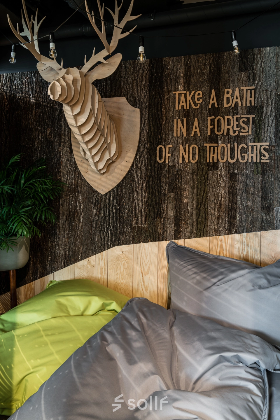Cozy lounge area with beanbags, creative wall decor, and unique wooden animal sculpture at Konstruktorska 11, in Warsaw Mokotow office space rental.
