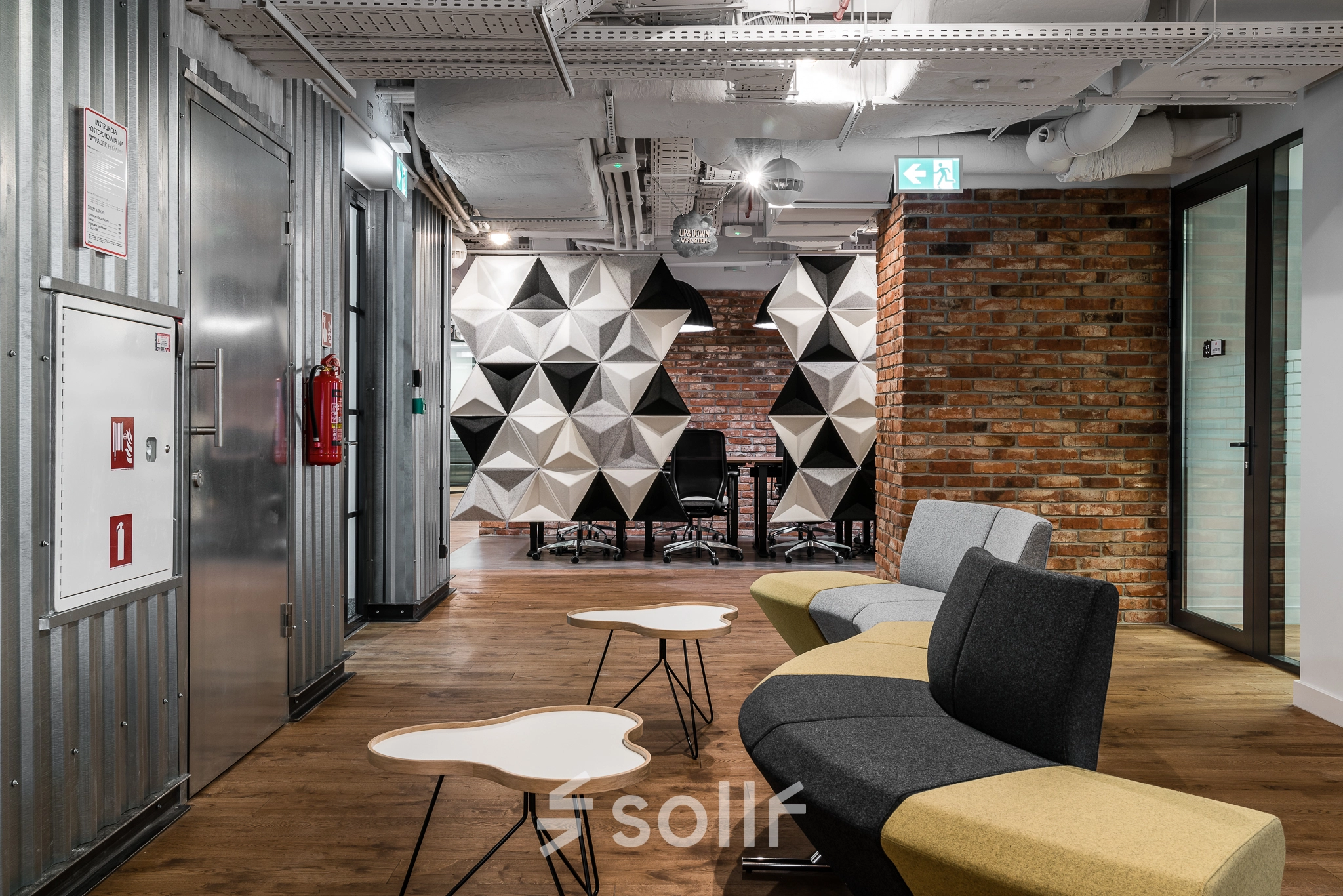 Modern office interior at Konstruktorska 11, Warsaw Mokotow with stylish seating area and unique geometric decor, ideal for office space rental.