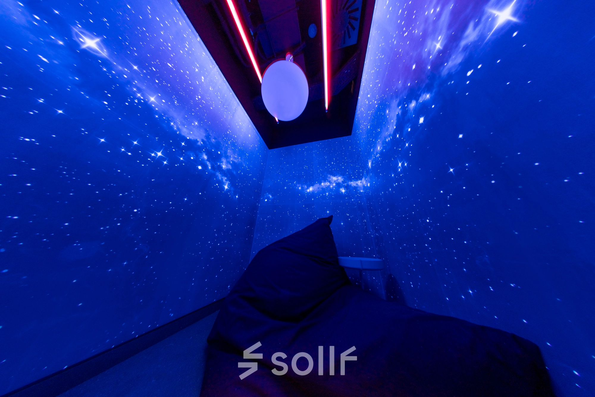 A furnished space at Al. Jerozolimskie 181B, Warsaw Ochota, with starry blue walls and a comfortable bean bag chair, ideal for office space rental.