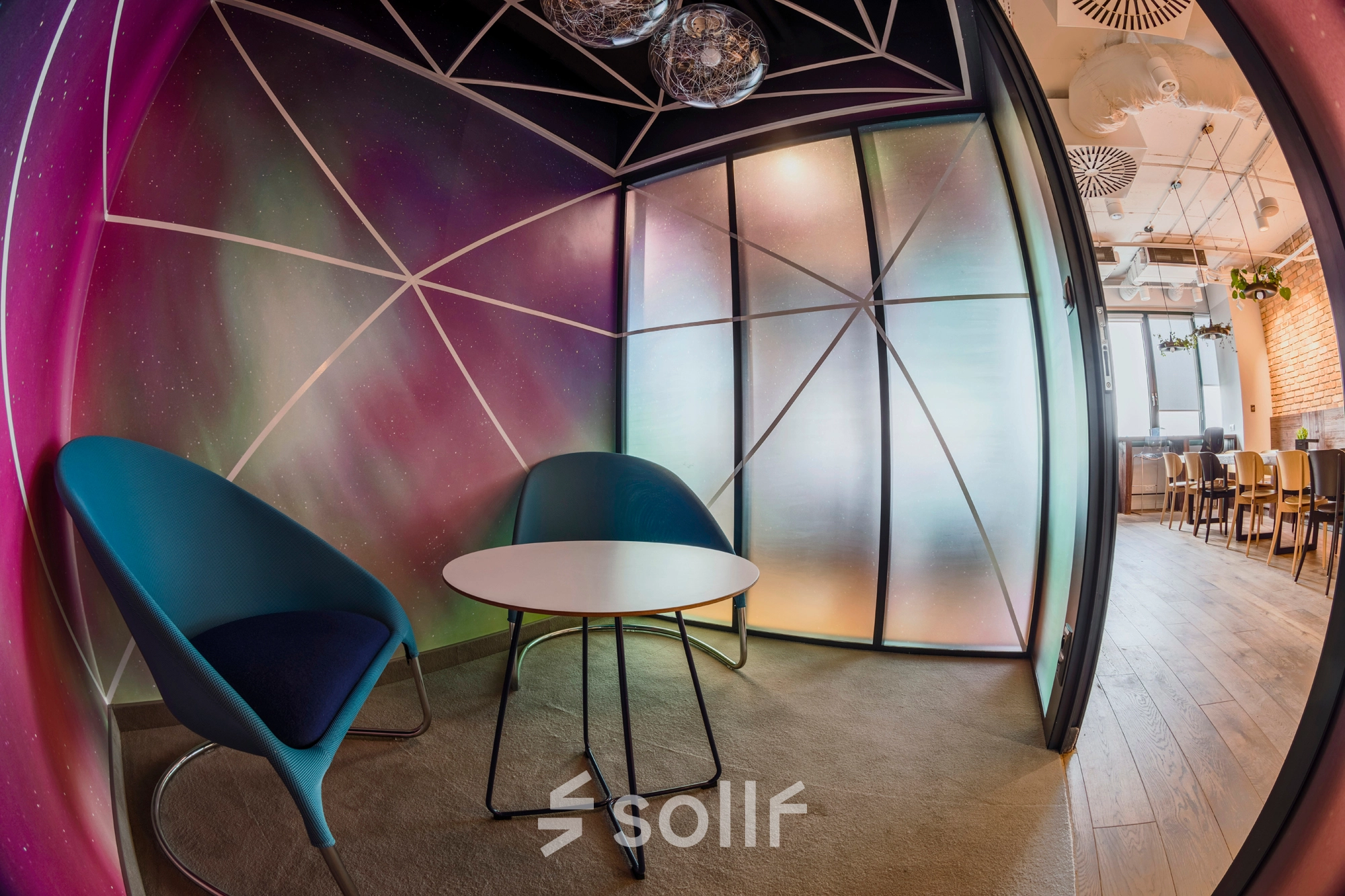 Modern, furnished meeting area in an office space at Al. Jerozolimskie 181B, Warsaw Ochota. Perfect for office space rental with stylish chairs and colorful walls.