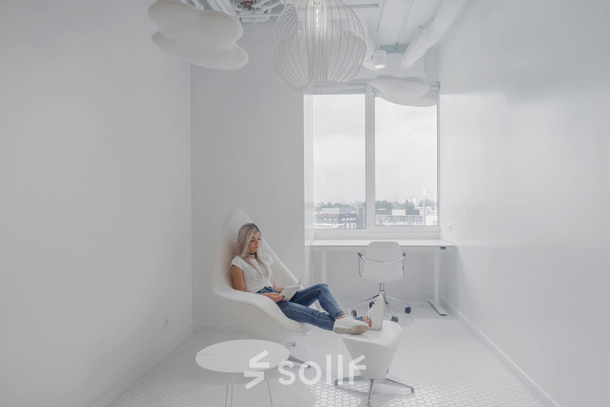 Bright office to rent at Al. Jerozolimskie 181B, Warsaw Ochota, featuring a modern, minimalist workspace with a woman working on a laptop.