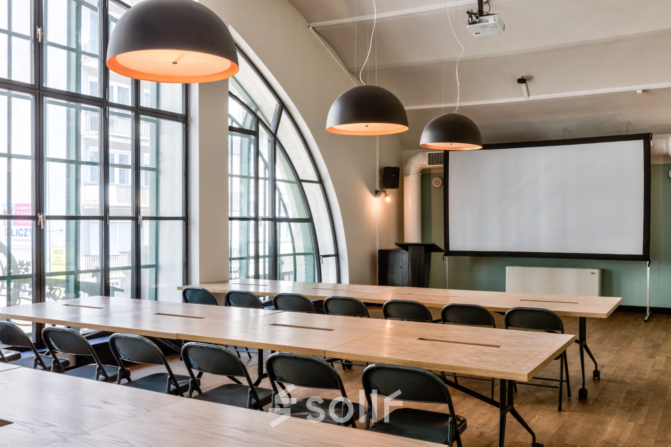 Spacious, well-lit conference room at Koszykowa 61, Warsaw Śródmieście, ideal for office space rental, featuring large windows, modern lighting, and ample seating for productive meetings.