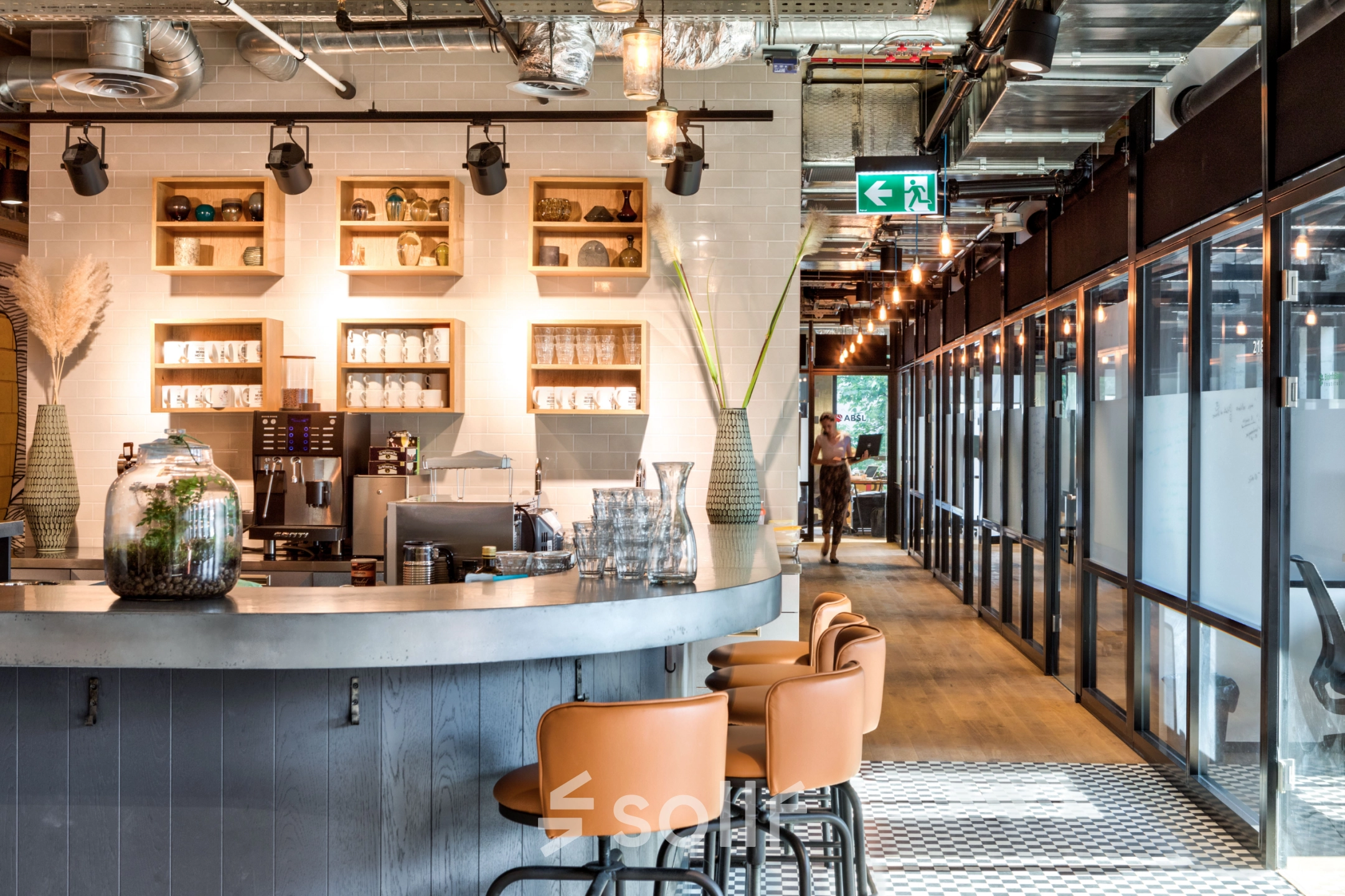Modern furnished office space for rent at Koszykowa 61, Warsaw Śródmieście, featuring a stylish open-floor plan with sleek lighting and bar seating.