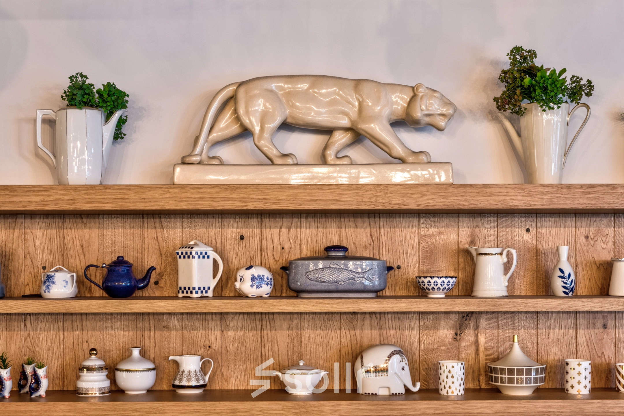 Decorative shelves in an office at Koszykowa 65, Warsaw, featuring ceramics and plants.