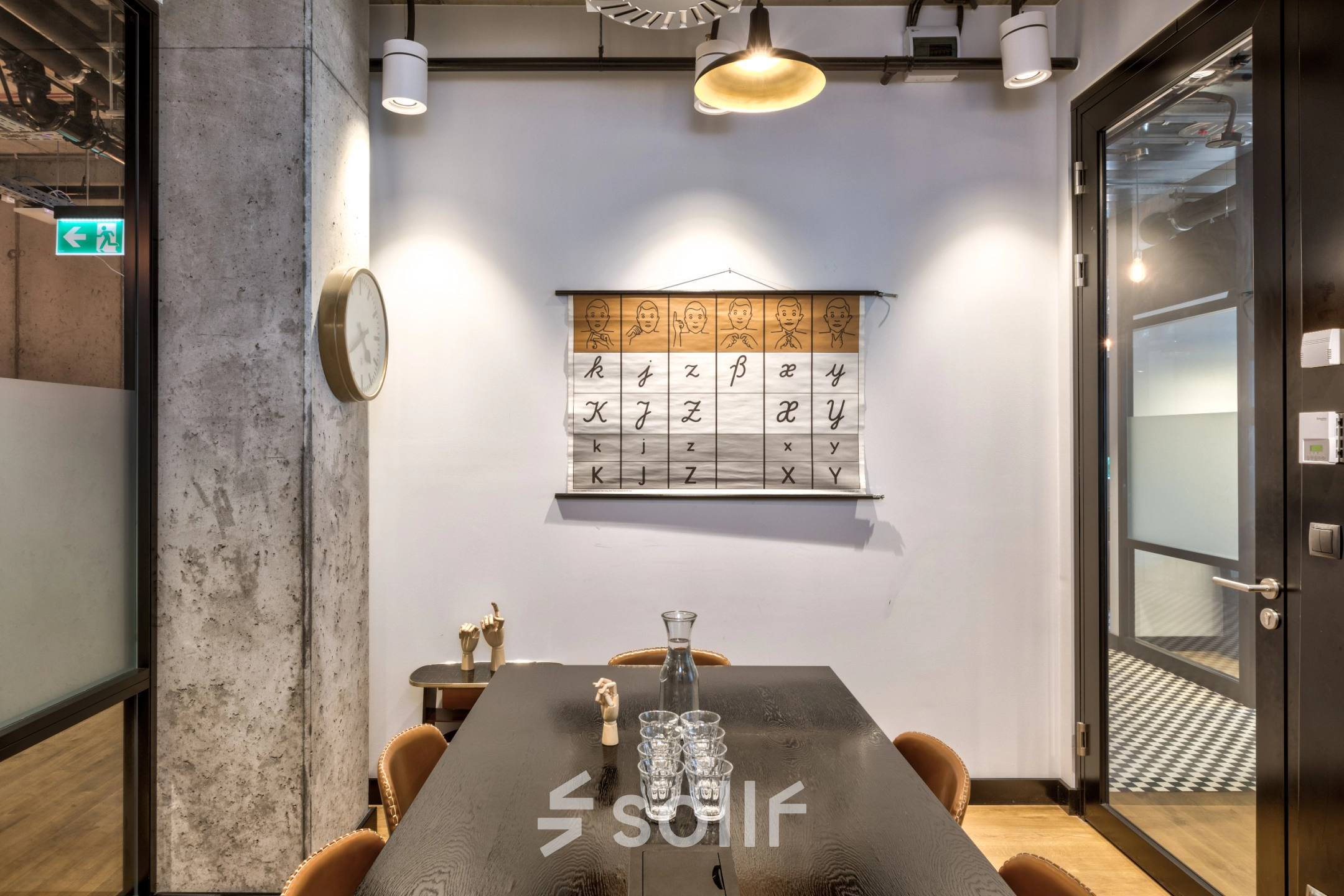 Modern office space rental at Koszykowa 65, Warsaw Śródmieście, featuring a cozy meeting area with a large table, chairs, and stylish decor.