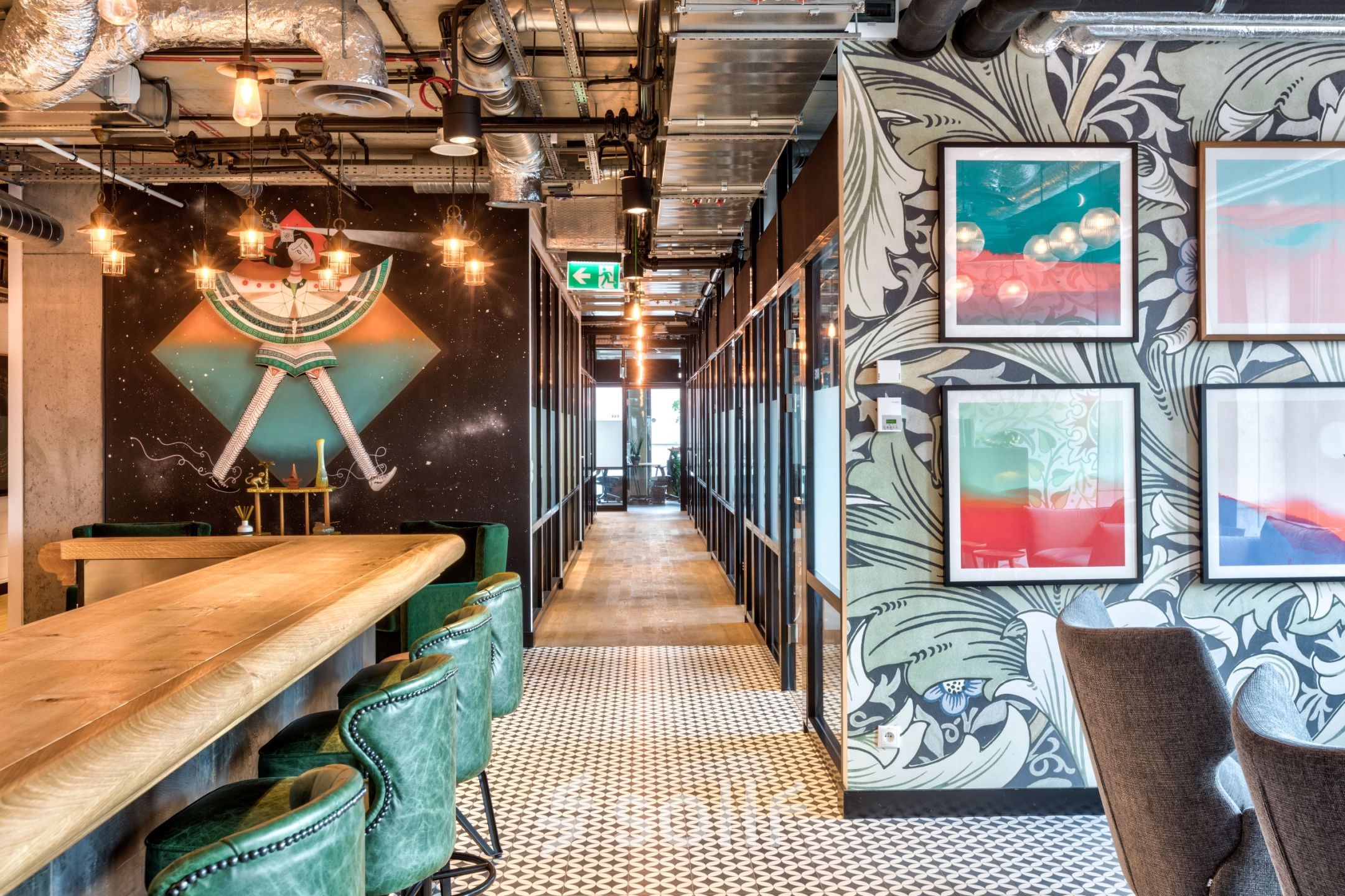 Modern office space with stylish decor, featuring green chairs and artwork on the walls, perfect for office space rental at Koszykowa 65, Warsaw Śródmieście.