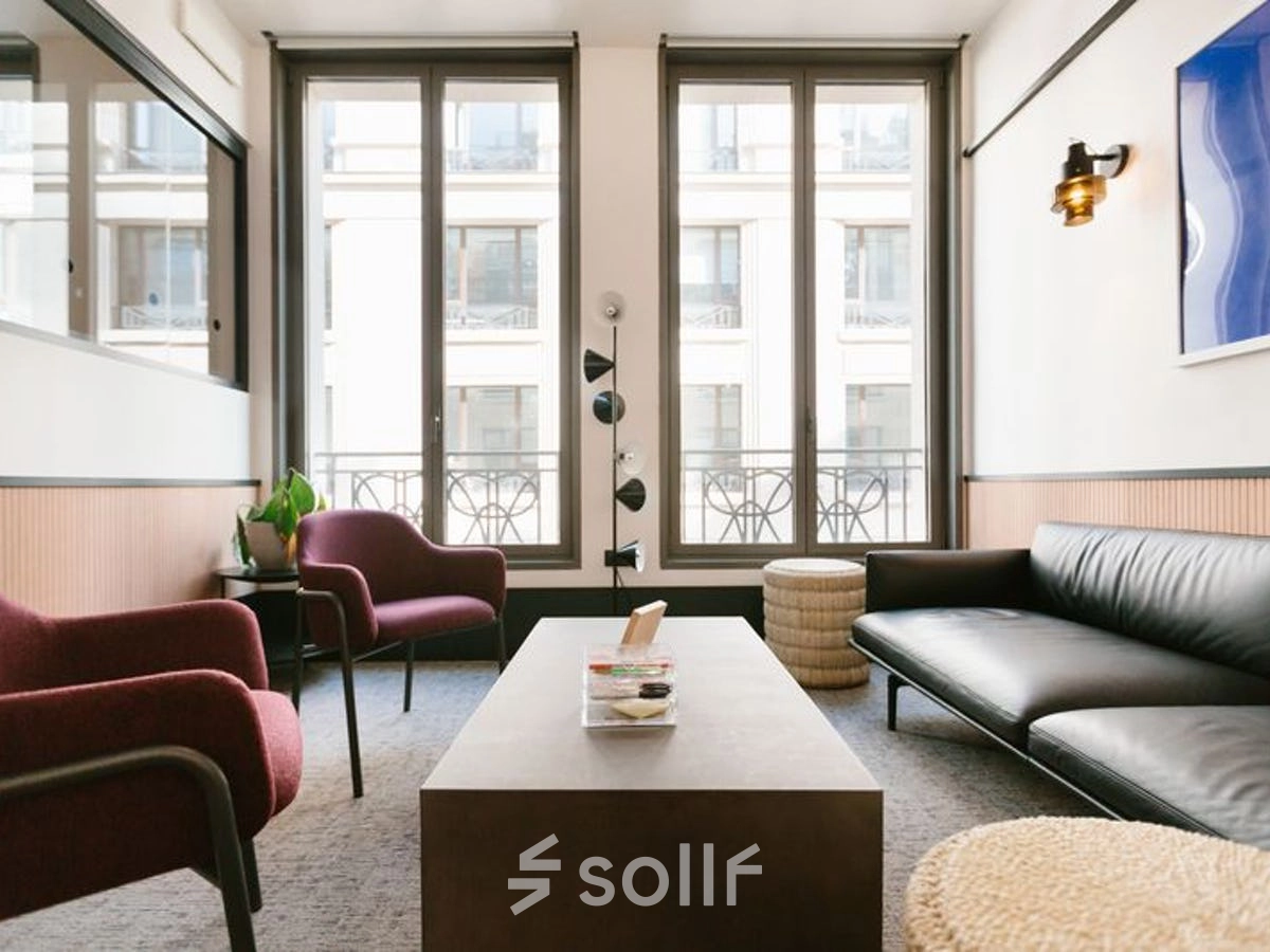 Modern office space with a sleek sofa, coffee table, and two chairs, ideal for office space rental in Warsaw Śródmieście.